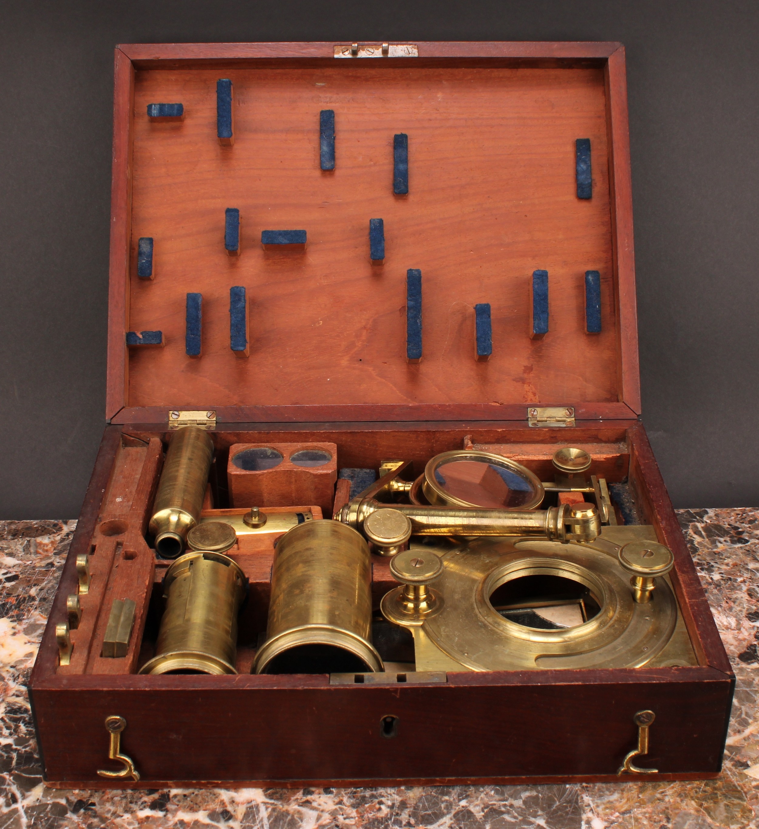 A George III lacquered brass solar microscope, two-part tube, rack and pinion focusing, long mirror, folding Y-shaped stand, various accessories and accoutrements, fitted mahogany box 31cm wide, late 18th/early 19th century