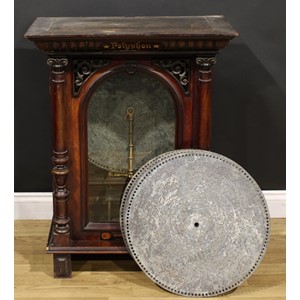 A 19th century coin operated penny-in-the-slot polyphon, the vertical movement playing 50cm discs, retailers label for H. Peters & Co, London and Charles McCann, 15 & 17 Osmaston Road, Derby, 90cm high, 69cm wide, 39.5cm deep, c.1890