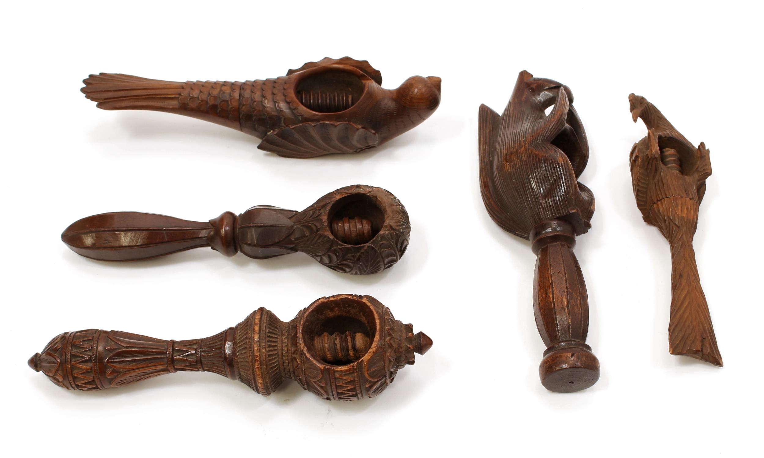 Nutcrackers - a Black Forest novelty screw-action nut cracker, carved as a squirrel, 18cm long, early 20th century; another, as a bird, 18cm long; others (5