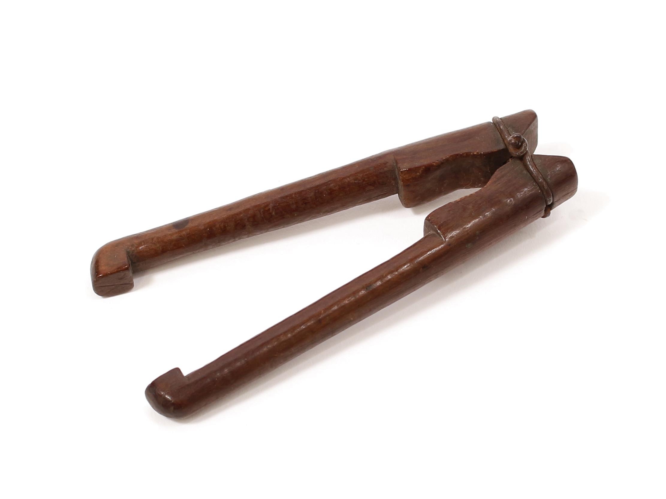 Nutcrackers - an 18th century lever-action nutcracker, of primitive construction, wire hinge, 9.5cm long