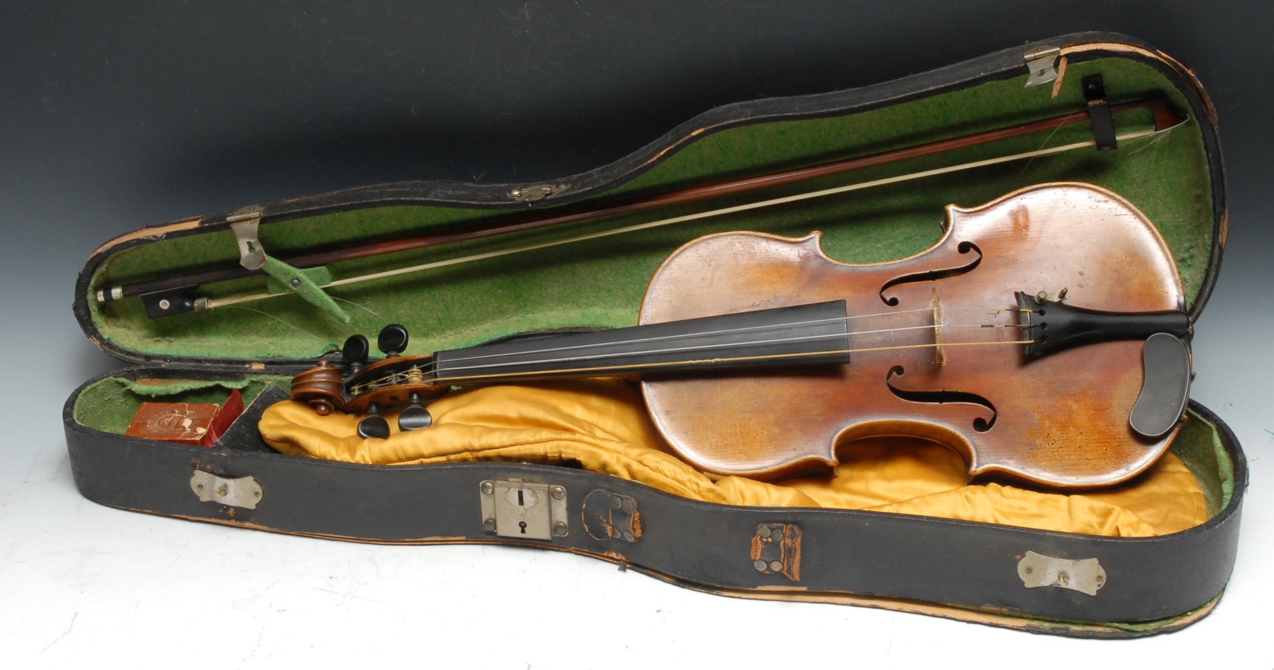 A violin, the two-piece back 35.75cm long excluding button, paper label Straduarius Cremonensis Faciebat Anno 1730, stamped to verso Solo Artist Violin, ebony tuning pegs, outlined throughout with purfling, 60cm long overall, the bow apparently unsigned, cased