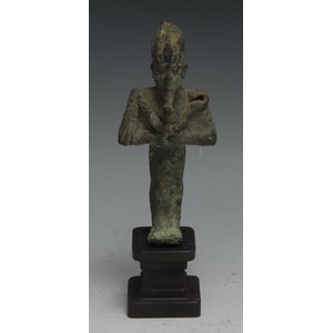 Antiquities - an Ancient Egyptian bronze figure, of Osiris, he stands, holding implements, 11cm high, Third Intermediate Period, c.1050 - 730 BC  Provenance: Antiquities - an Ancient Egyptian cartonnage sarcophagus fragment, 12cm x 7cm, late New Kingdom culture, 19th Dynasty, c.1292 - 1189 BC   Provenance: Acquired by the vendor from the private collection of Ken Mannion, Barton-upon-Humber 13/07/21, he having obtained it in exchange for work undertaken for the owner of Helios Gallery Antiquities. Purcased by them from a private collection in Dorset.