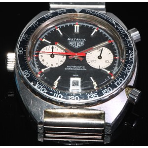 Heuer - Autavia, ref 1163, a stainless steel chronograph bracelet watch, no. 246191, black dial with silver sub dials, applied luminous silver baton hour markers, pointed steel hands with luminous inserts, black sub dial hands and red seconds recording hand, date aperture to 6 o’clock, black bezel with Arabic numeral, automatic movement, 17 jewels unadjusted, cal. 11, screw down case back, case, dial, crown, movement and bracelet signed, on a stainless steel bracelet with folding clasp, diameter 42mm, associated strap