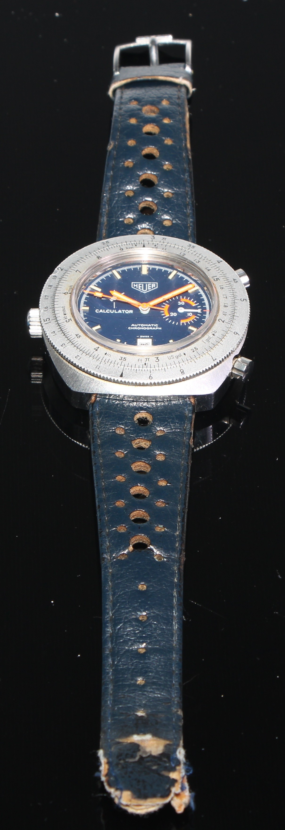 Heuer - a Calculator, ref. 150.633, a stainless steel chronograph wristwatch, no. 284636, circa 1970s, automatic movement,  deep blue dial with applied luminous baton markers, orange luminous pointed hour and minute hands, white sub dial hands, orange seconds hand, date aperture to 6 o’clock, silver rotating slide rule bezel, screw down case back, case, dial and movement signed, on a conforming leather strap with signed pin buckle, diameter 45mm.