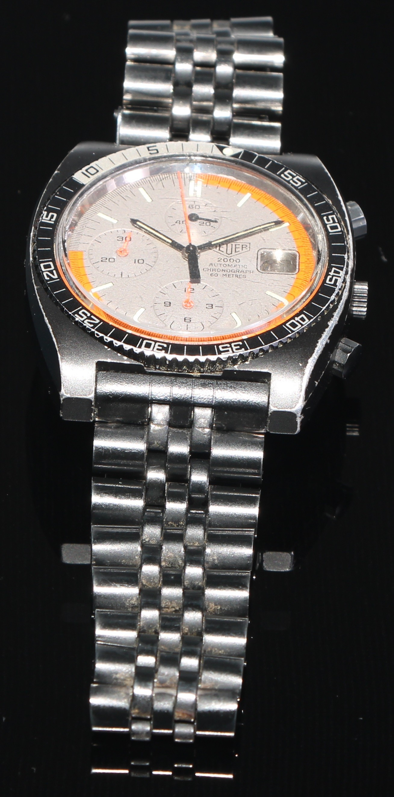 Heuer - a 2000 series (Soccer) automatic 183.006 chronograph wristwatch, textured dial, block baton, orange grey two tone minute track, three subsidiary registers, orange centre seconds, rotating bezel, black case water resistant to 60 meters, original black bracelet strap, deployment buckle, 39mm wide. c.1984