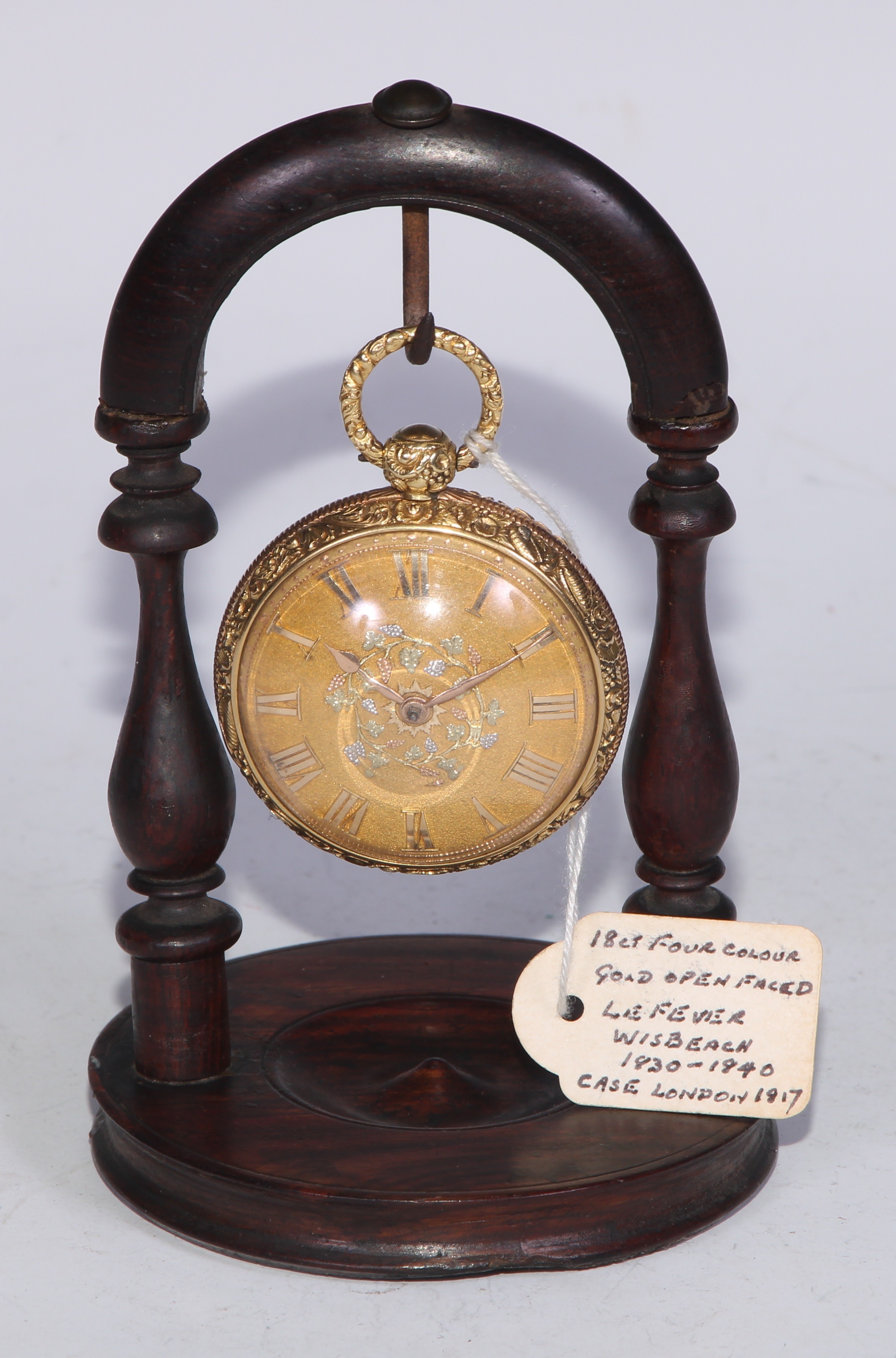 A George III 18ct four-colour gold open faced pocket watch, by [George] LeFever, Wisbech, 4cm matted dial applied with Roman numerals, centred by a band of fruiting vine, verge fusee movement, the case chased with flowers and scrolling foliage, engine turned to verso, 6.5cm over loop, London 1817, 92g gross