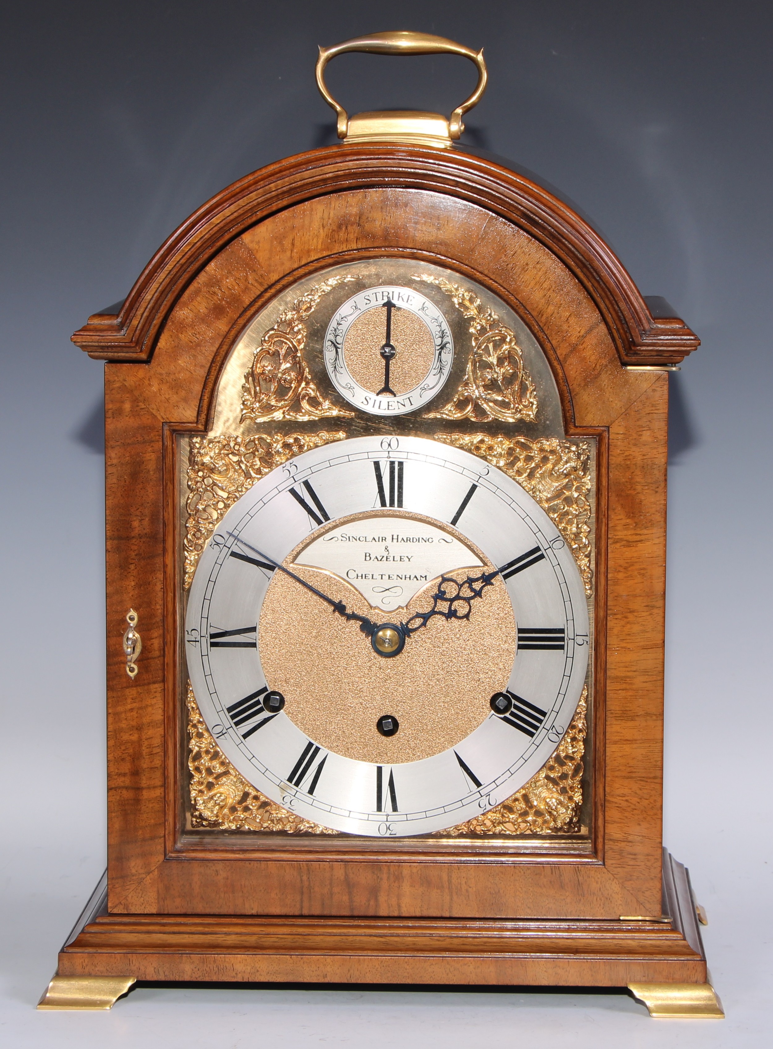 A George III design gilt metal mounted mahogany musical bracket clock, 18.5cm silvered chapter ring, inscribed Sinclair, Harding and Bazeley, Cheltenham, Roman numerals, Arabic subsidiary numerals, three wining holes, triple fusee movement, alternating strike/silent, inset spandrels, the case quite plain, 47cm high over handle
