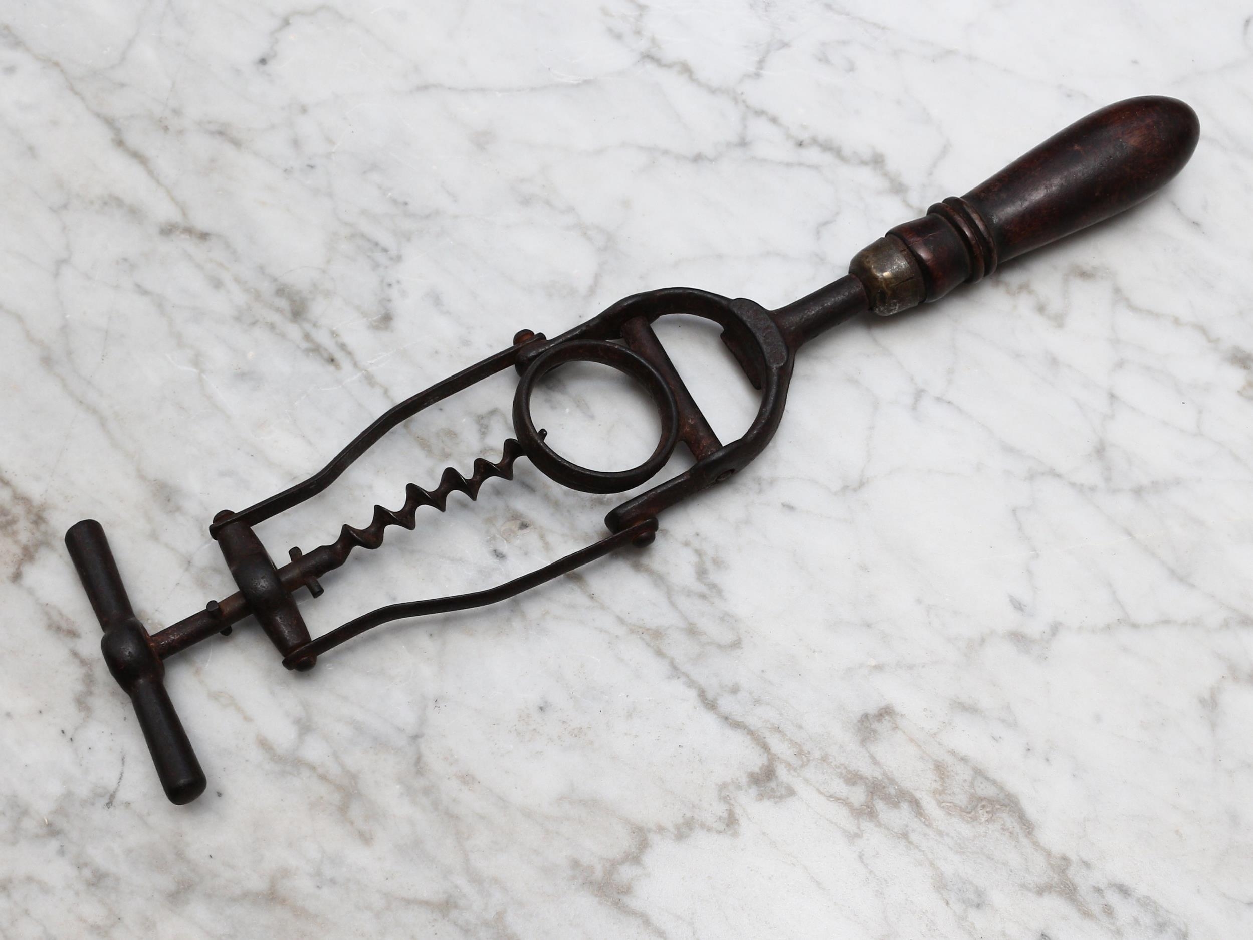 Helixophilia - an unusual early 20th century lever corkscrew, pivoting mechanism with neck ring, turned handle, 32.5cm long overall