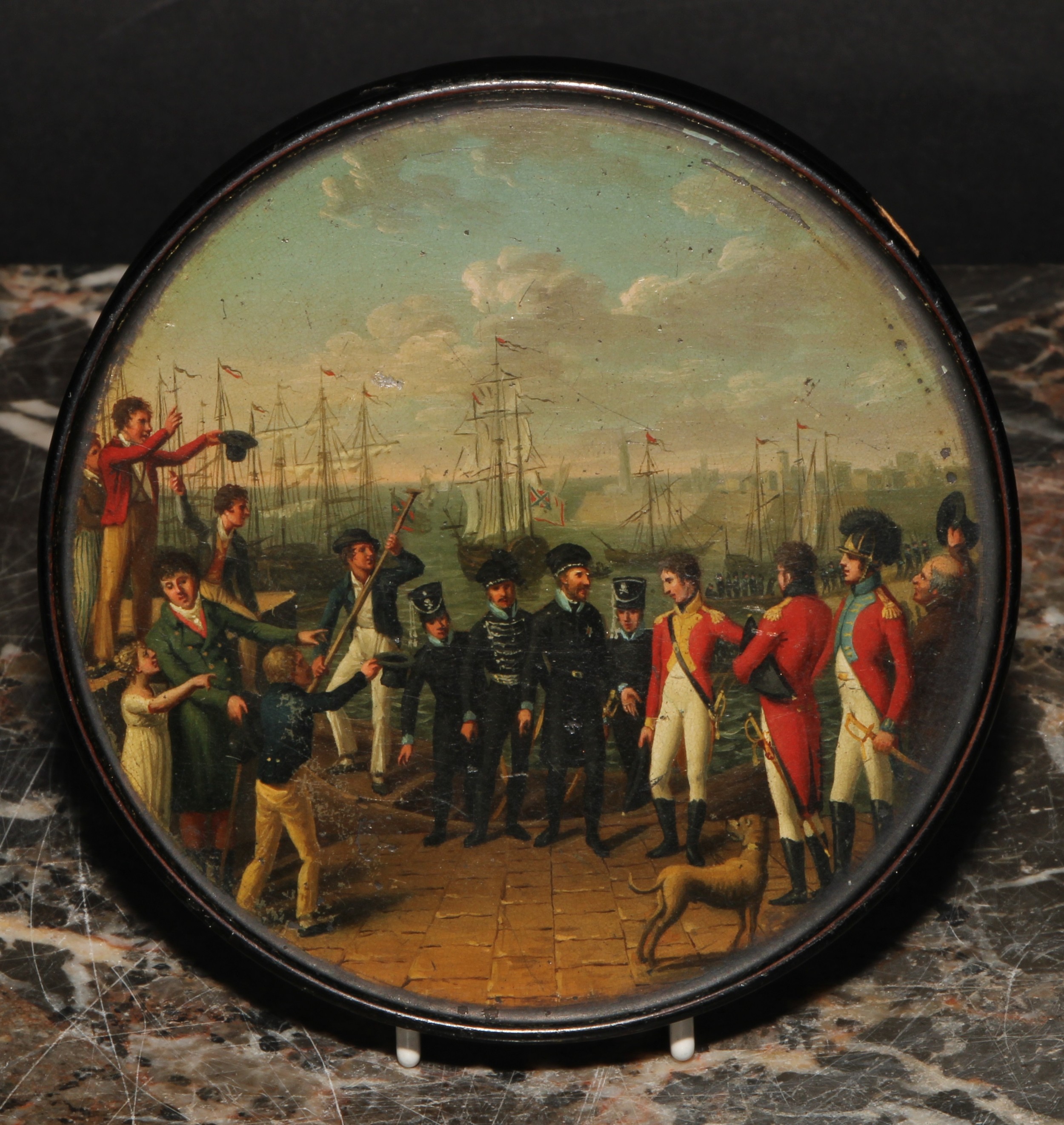 The Napoleonic Wars and the War of the Fifth Coalition - an early 19th century papier mache cicular snuff box, attrubuted to Stobwasser, the cover painted with a titled scene, Ankunft des Herzogs von Braunschweig Oels in England, depicting the arrival of Frederick William, Duke of Brunswick-Wolfenbüttel in England in 1809,  10cm diameter, early 19th century