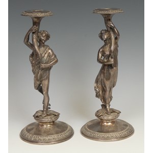 A pair of sculptural Victorian silver figural candlesticks, cast as a Bacchic reveller and  maenad raising aloft a cornucopia, domed circular bases with acanthus borders, 25.5cm high, Stephen Smith & Son, London 1865
