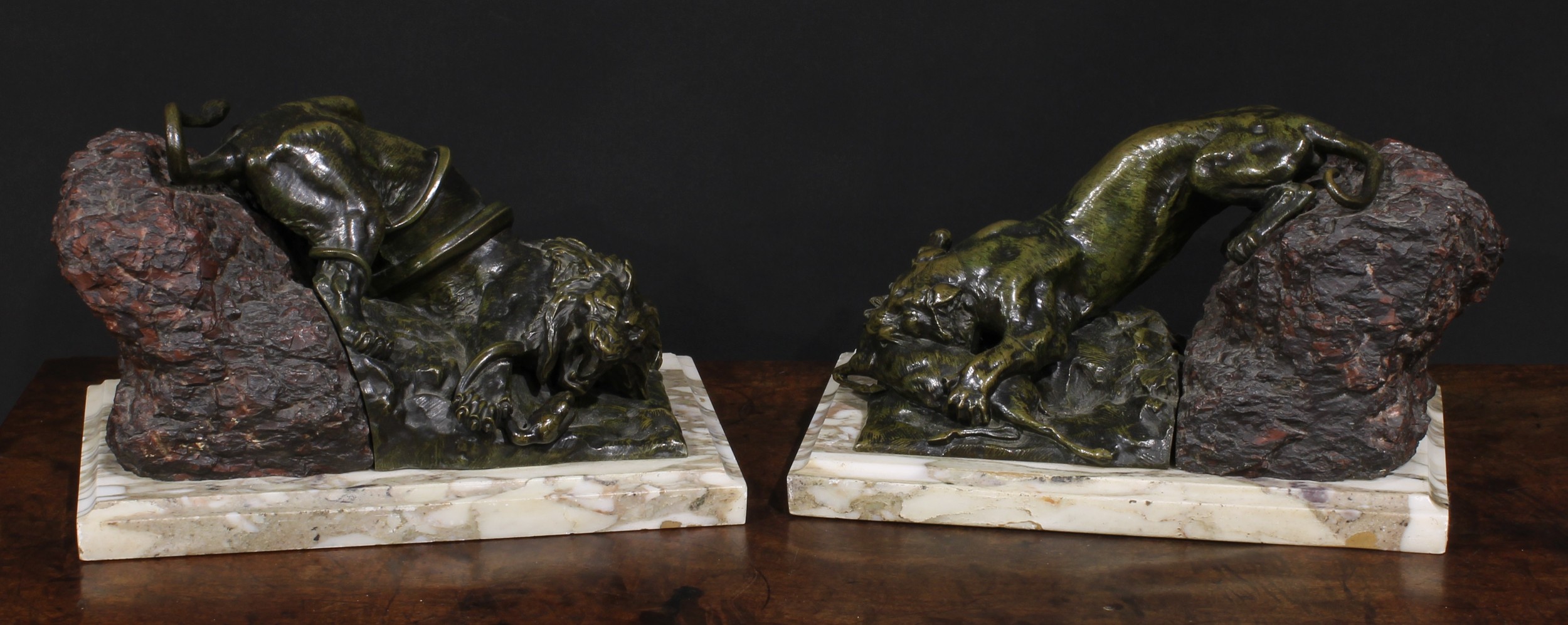 Continental School, 19th century, a pair of patinated bronze and stone sculptures, Combat, a lion in battle with a snake, a lioness with kill, marble bases, 31cm wide