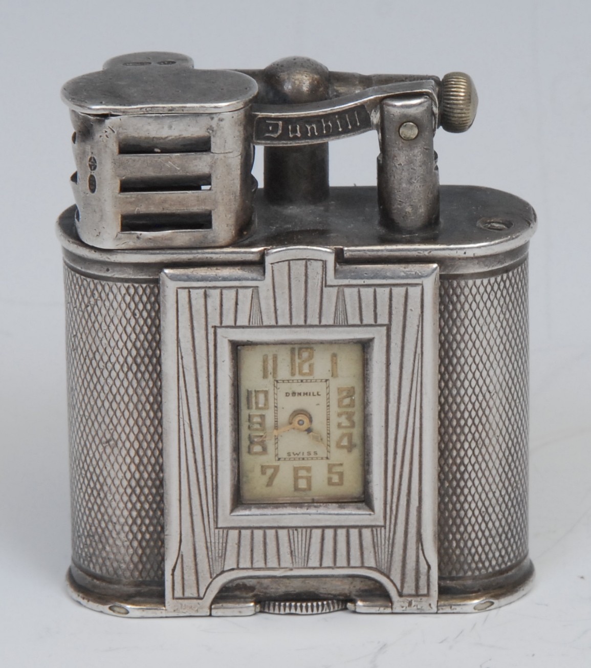 An Art Deco silver Dunhill combination cigarette lighter and watch, 1.3cm champagne dial with gilt Arabic numerals, engine turned, 5cm high, 4.3cm wide, Patent No. 143752, import mark for London 1928