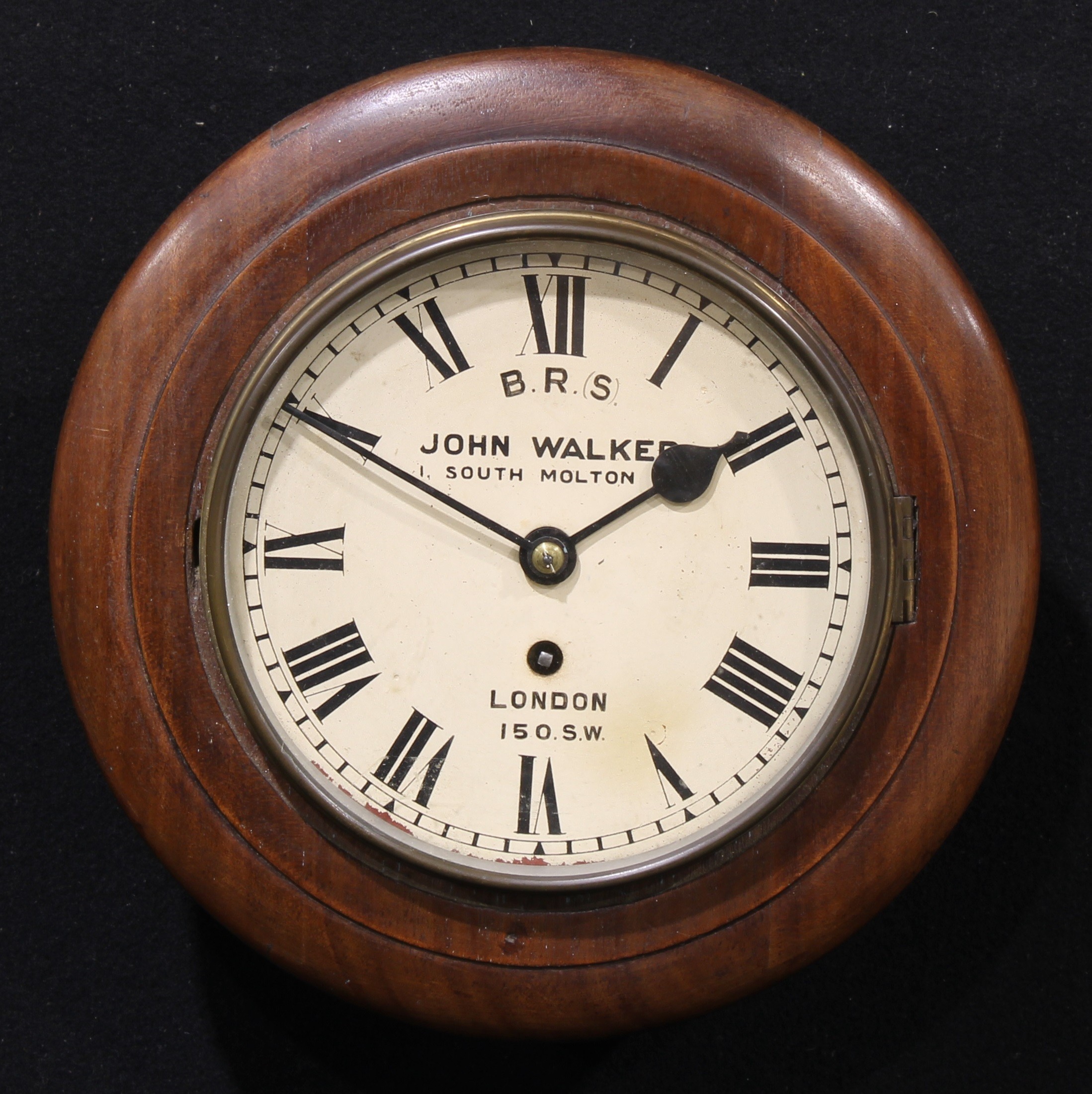 Railwayana - a late Victorian mahogany circular wall clock, Roman numerals on cream dial, inscribed B.R.(S), JOHN WALKER, 1 SOUTH MOLTON ST, LONDON 150.S.W., brass bezel, single train fusee movement, the case verso stamped 150 SW, 30.5cm diameter  Probably London & South Western Railway, later inscribed B.R.(S), [British Rail South]