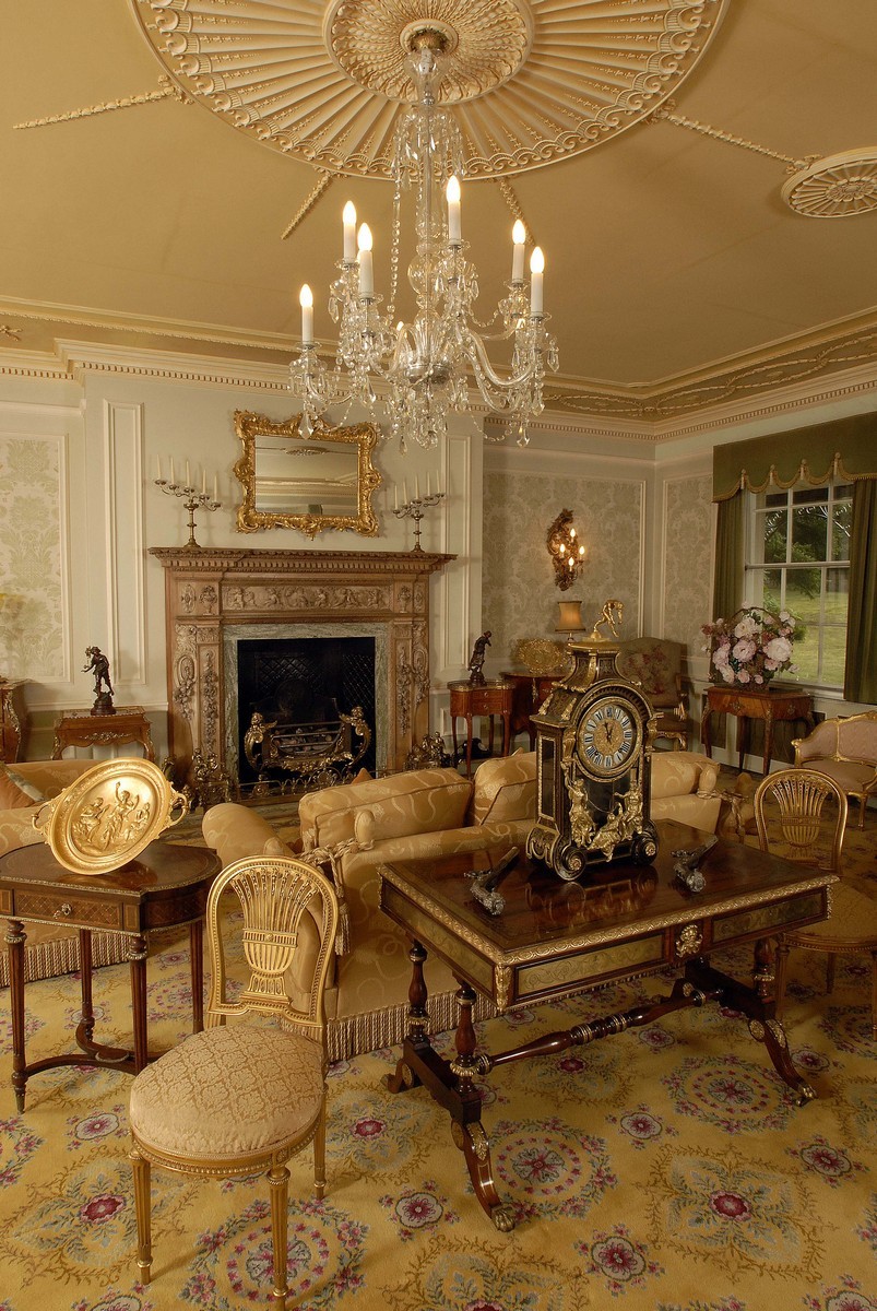A Regency ormolu mounted rosewood and brass marquetry rectangular library table, attributed to John McLean, the well figured oversailing top inlaid to the angles with scrolling leafy tendril brackets, outlined with bands engraved with stiff leaves and flowerhead roundels within a substantial border cast with oval paterae and stiff leaves, the conforming frieze with a rectangular drawer and a blind drawer, divided by a boldly cast 'Green Man' foliate mask, the verso conforming in reverse, end supports each with a pair of turned pillars with egg and dart mounts, ring turned stretcher, sabre legs applied with acanthus leaves and flowerhead paterae, brass lion paw casters, 72.5cm high, 119cm wide, 73cm deep, c.1805    John McLean of Upper Terrace, Tottenham Court Road and 34 Marylebone Street, Piccadilly is listed in the Westminster Poll Book in 1774 and included in Sheraton's Cabinet Dictionary of 1803. Trade directories 1809 - 14 give John McLean & Son, upholders, 58 Upper Marylebone Street and from 1814 - 25 give William McLean at the same address who may be a relative. McLean is known particularly for his fine cabinets and desks in the French taste with brass mounts and inlay and advertised that he specialised in 'Elegant Parisian Furniture'  Collard, Frances, Regency Furniture, Antique Collectors' Club (Woodbridge 1985), p.332
