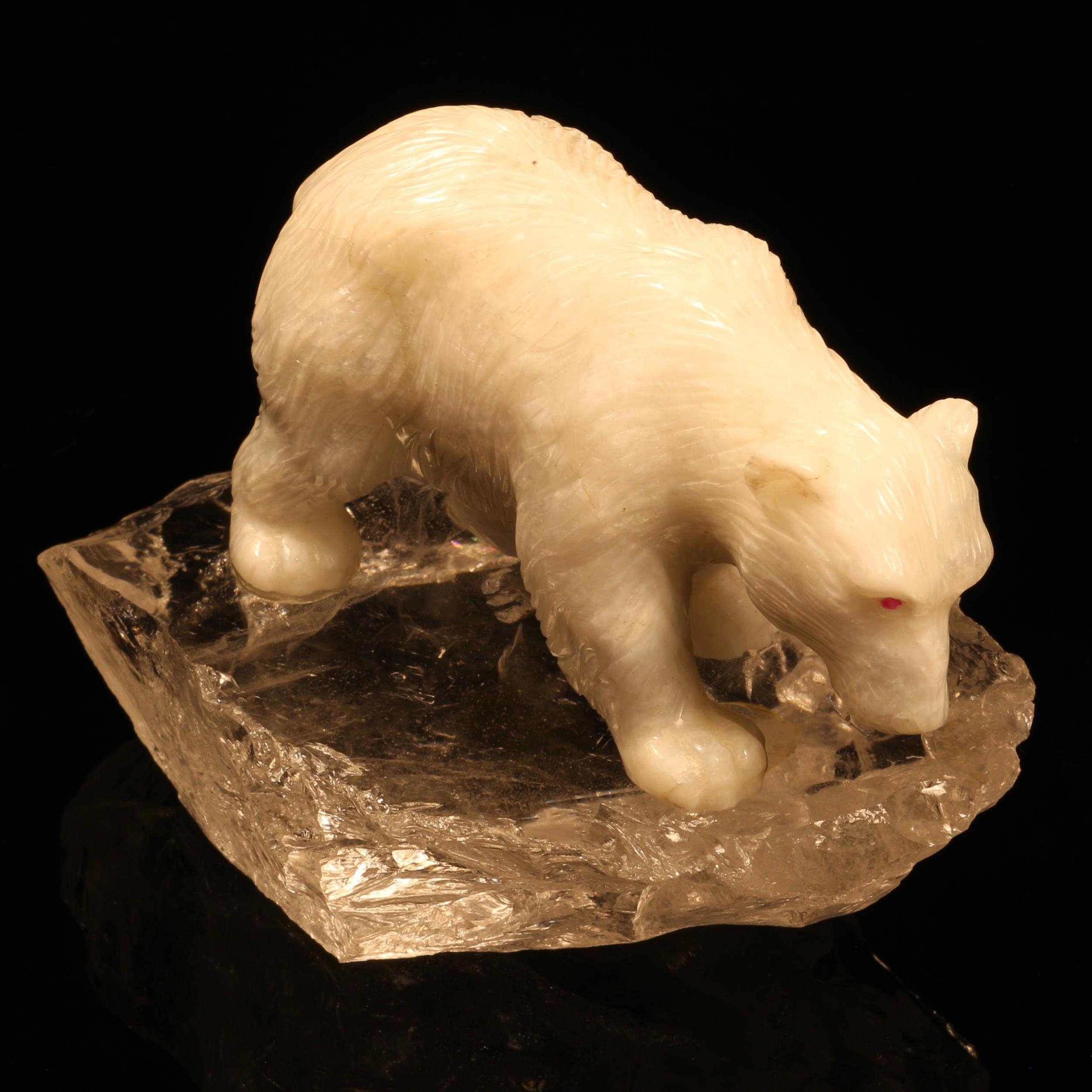 Alfred Lyndhurst Pocock (1882 - 1962), a white onyx carving, of a polar bear, four square upon a rock crystal iceberg, ruby eyes, unsigned, 13cm long