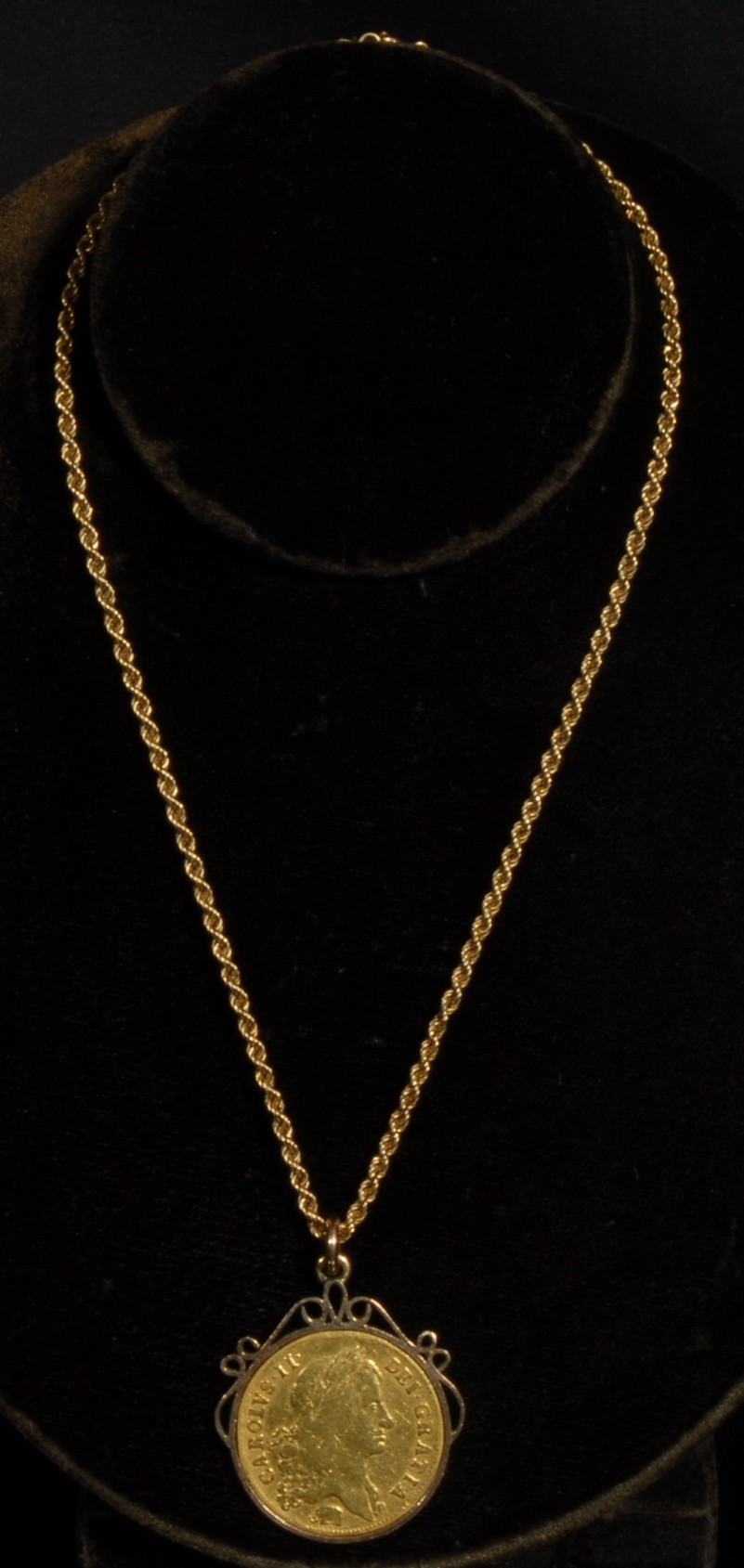 A Charles II 1664 gold 2 guinea, first laureate head facing dexter, Elephant below bust, CAROLVS. II. DEI. GRATIA. Verso, Crowned cruciform shields, emblematic sceptres and four interlinked c's to centre, 30mm in diameter, mounted, now with 9ct gold rope twist chain, 24.4g