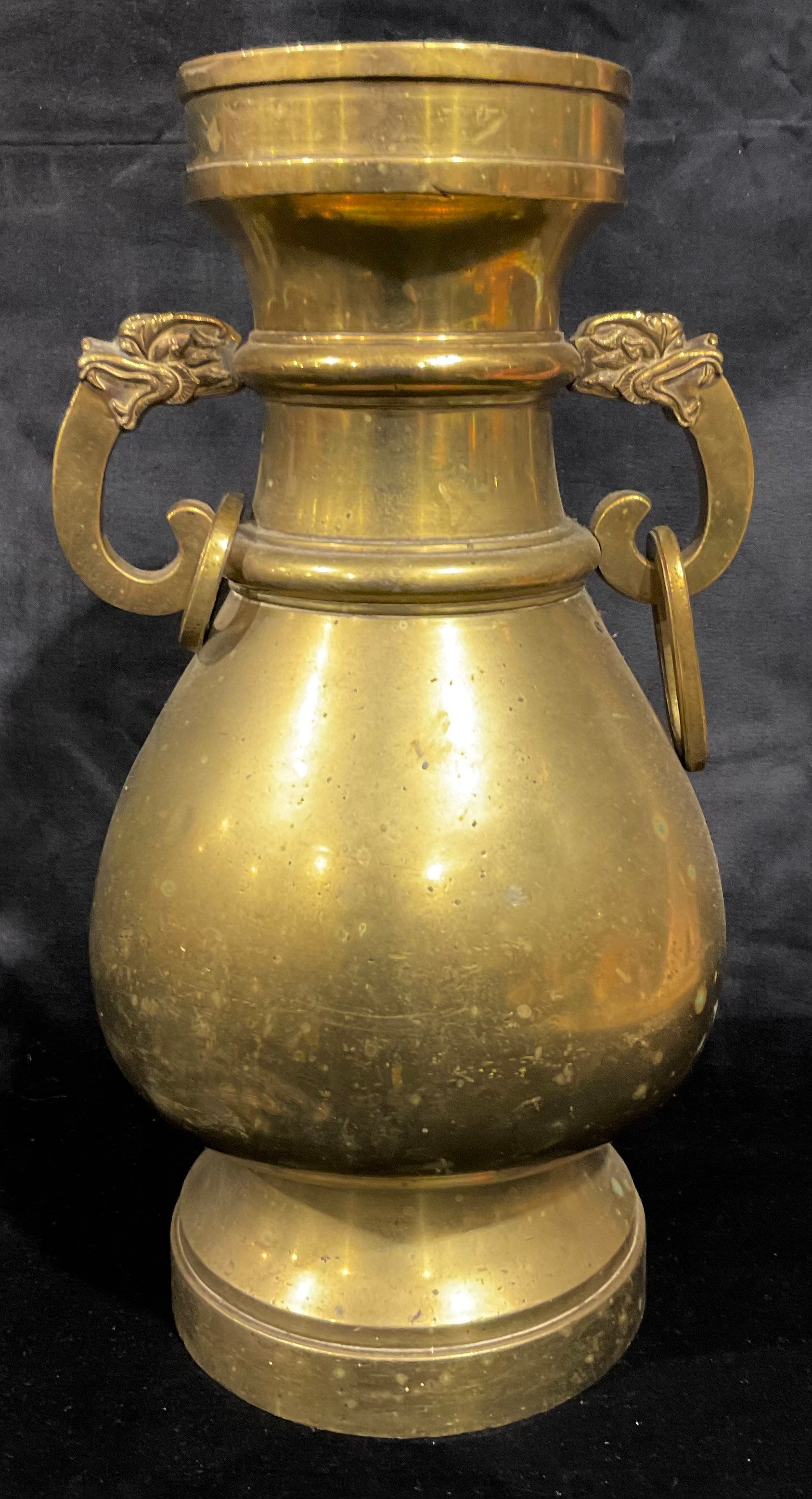 A Chinese bronze temple vase, of Yuan form, dragon mask loose ring handles, Qing Dynasty Qianlong reign mark to foot rim, 32cm high