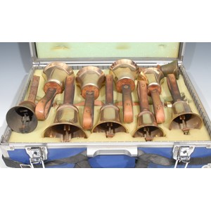 A set of ten brass hand bells, by The Whitechapel Bell Foundry, the G 21cm to top of leather strap, cased; two others (12)