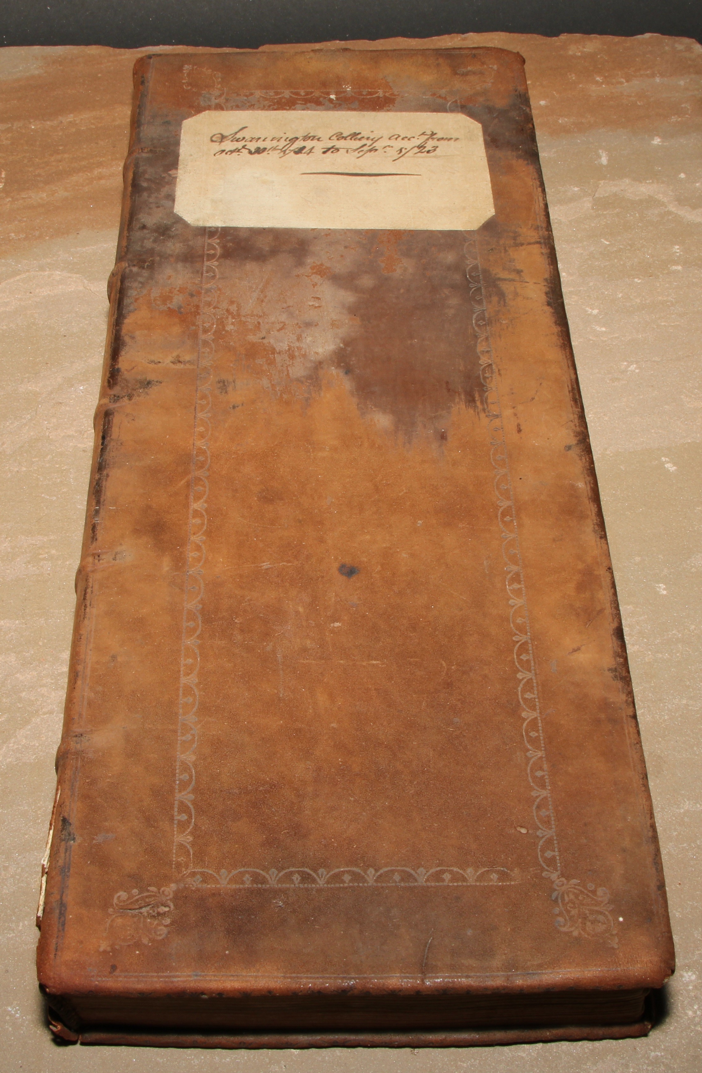 Mining Interest - an early 18th century Swannington Colliery [Leicestershire] accounts ledger, leather binding with paper label to cover inscribed 'Swanington Colliery acc. From Oct. 30th 1714 to Sept. 5/23', 41.5cm x 16.5cm
