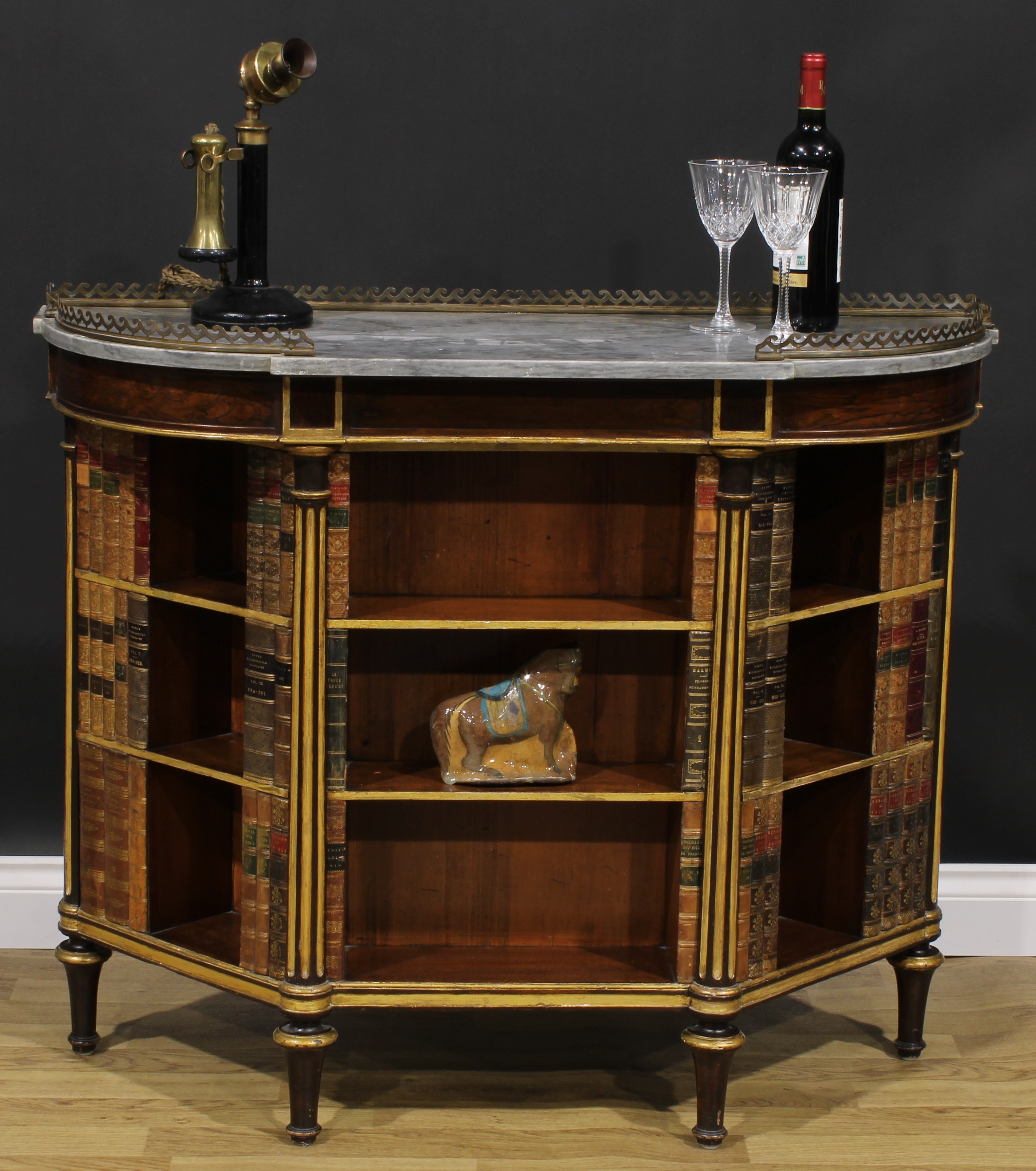 A 19th century parcel-gilt rosewood and mahogany low library bookcase, marble top above open shelves applied with fixed faux books, divided and flanked by fluted engaged columns, turned feet, 90cm high, 107cm wide, 39cm deep