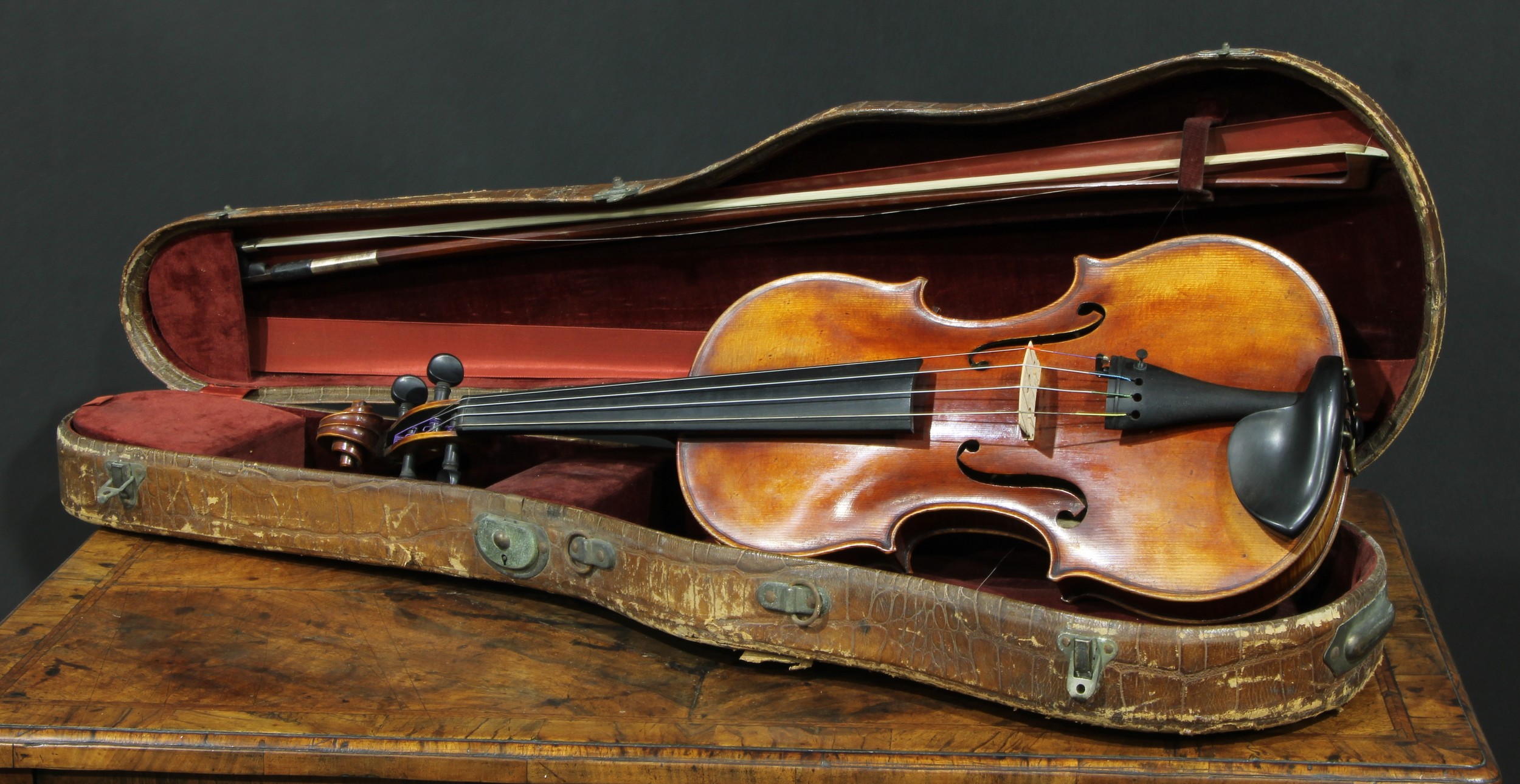 An Austrian violin, the one-piece back 60cm excluding button, paper label, Martinus Stoss, fecit Viennae [Vienna] 1810, ebonised tuning pegs, outlined with purfling, 60cm long overall, the bow unsigned, 74.5cm long, cased