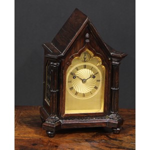A George/William IV Gothic Revival rosewood bracket clock, of small almost carriage proportions, 8cm gilt engine turned dial inscribed with a chapter of Roman numerals, Strike/Silent to arch, twin-winding holes, English fusee movement striking on a bell, the pointed arched case flanked by cluster columns, knop feet, 25cm high, c.1830