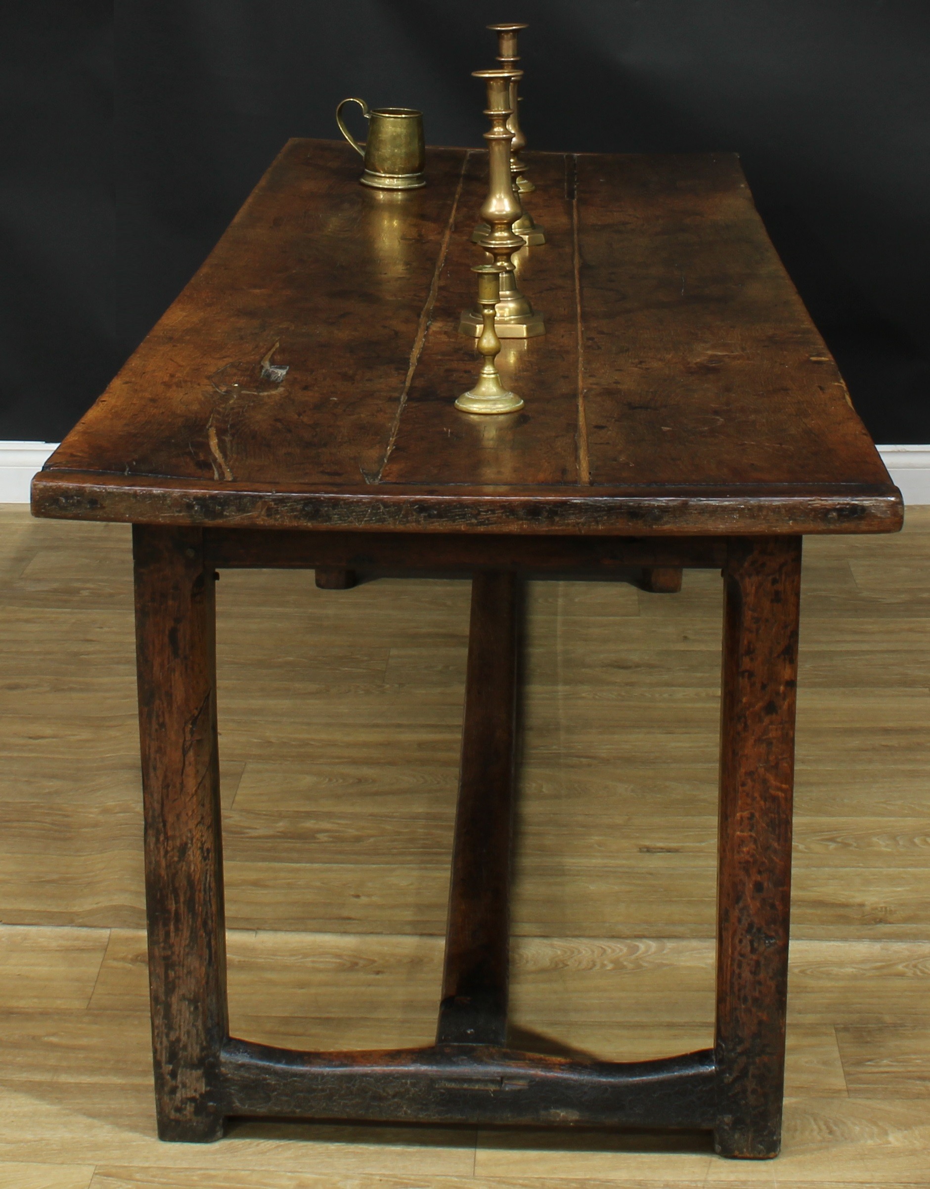 An 18th century oak country house servants' quarters refectory table, rectangular top, internally chamfered square legs, one inscribed HP, H-stretcher, 78cm high, 218cm long, 79.5cm wide