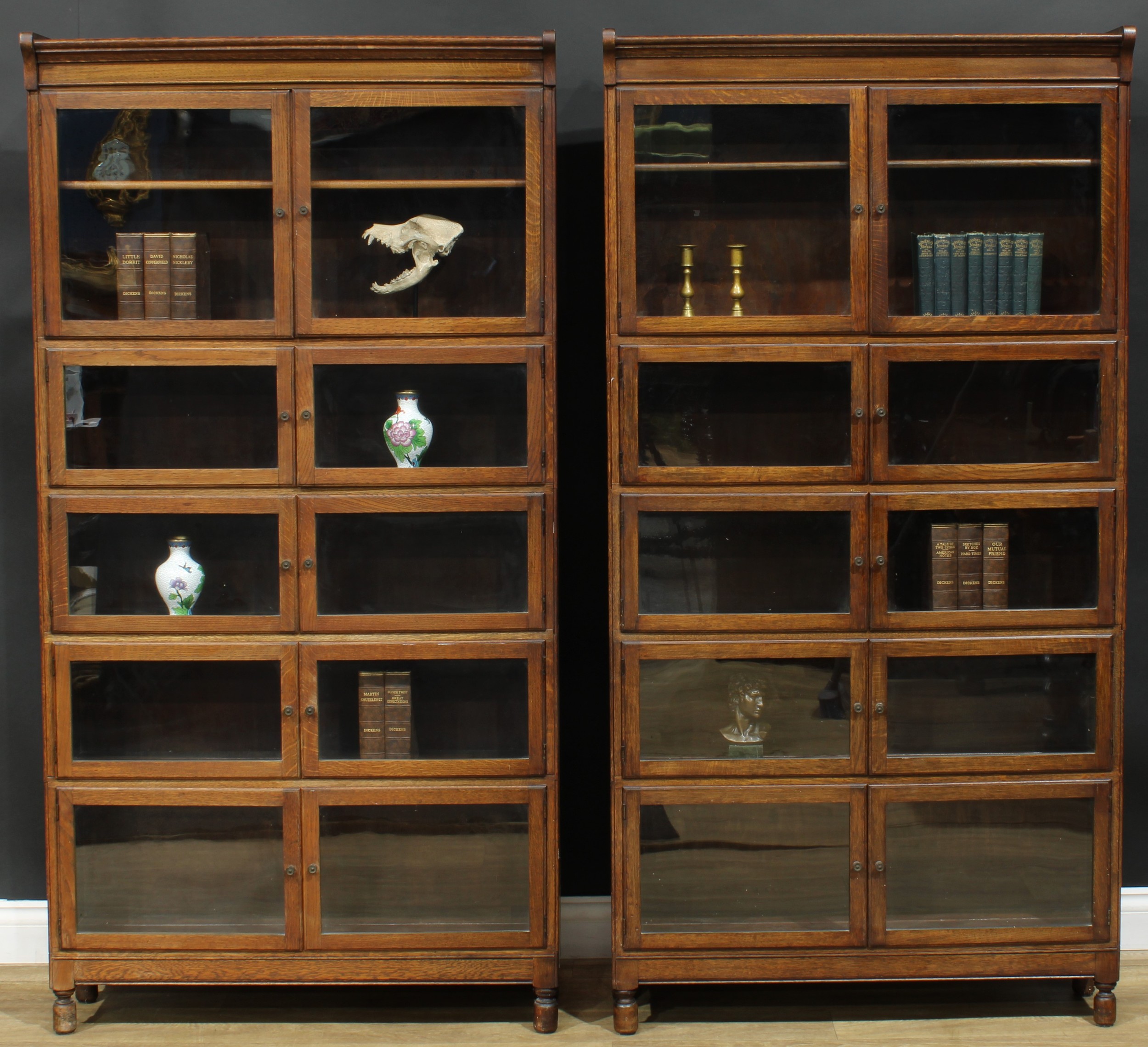 A pair of early 20th century oak modular stacking barrister’s bookcases, by Minty Limited, Library Specialists, Oxford, each 173.5cm high, 89cm wide, 26.5cm deep, c.1930