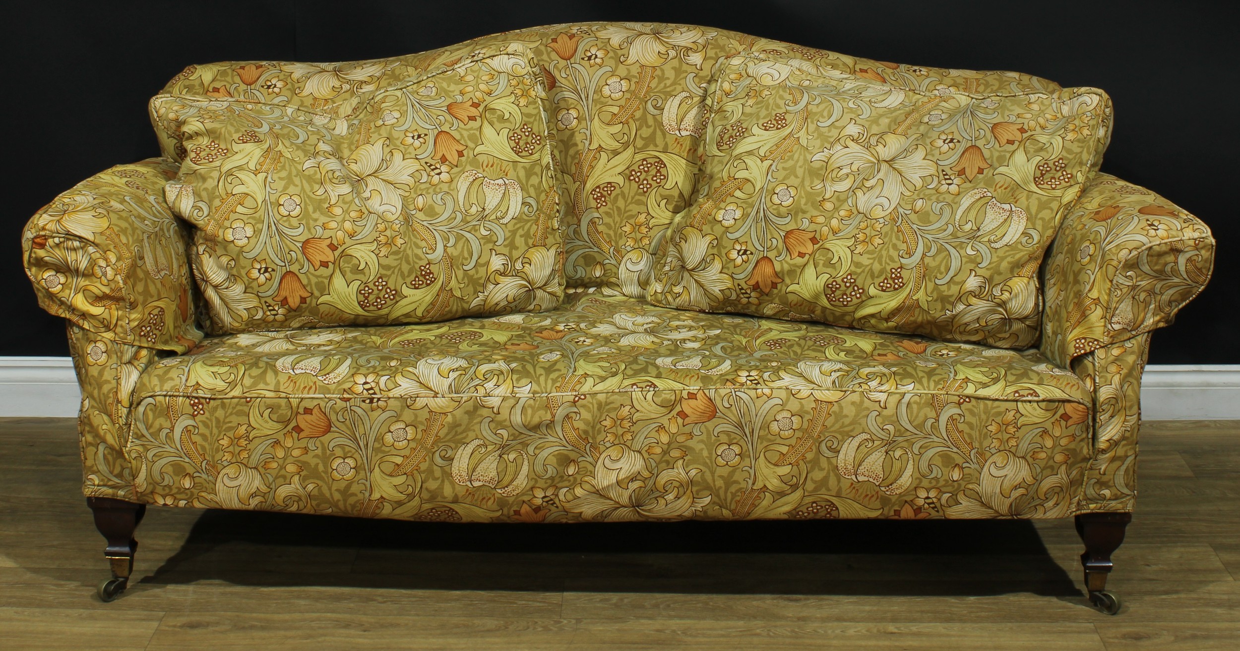 A 19th century country house sofa, serpentine cresting, stuffed-over upholstery, brass casters, 87cm high, 187cm wide, the seat 145cm wide and 56cm deep