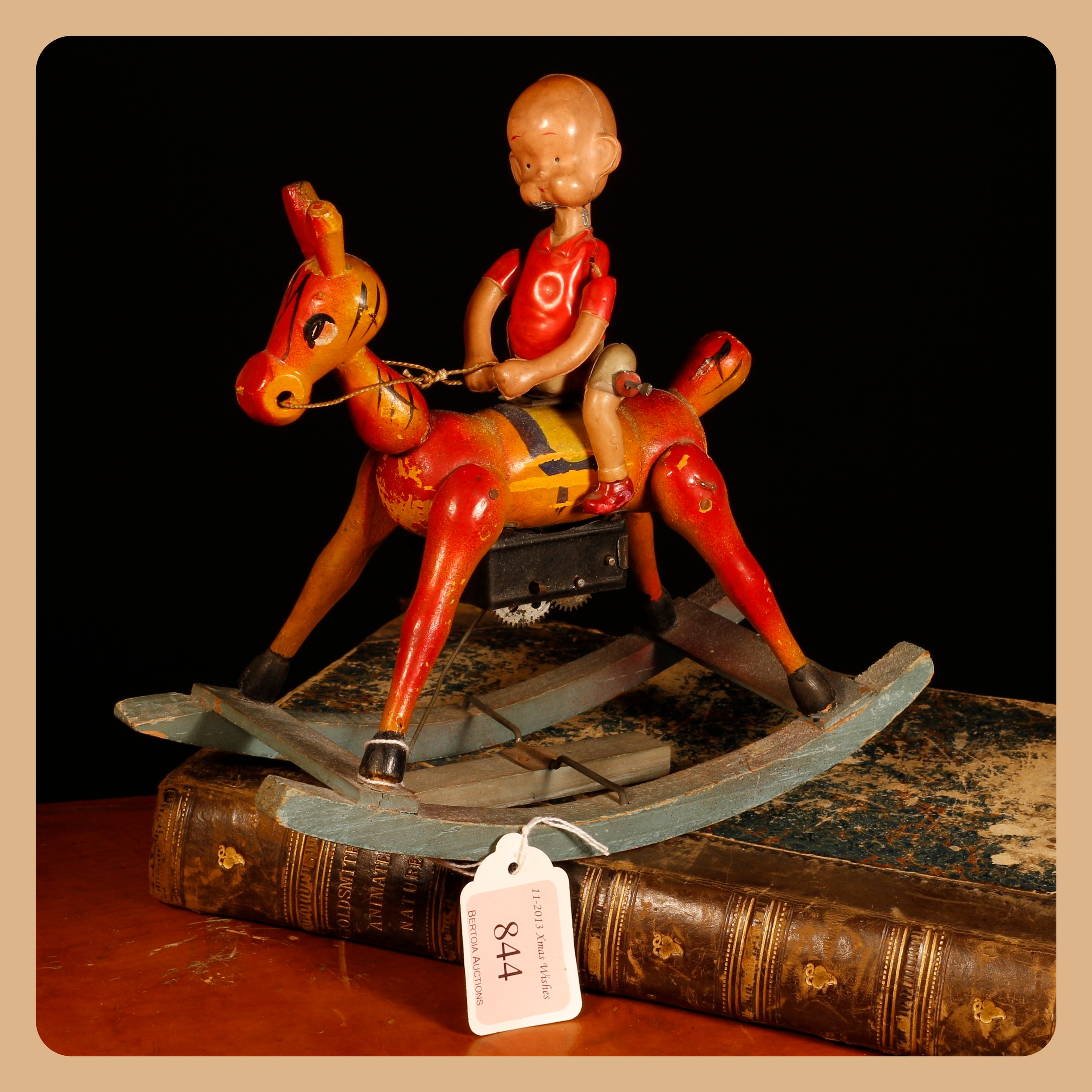 Henry, From Cartoon to Comic Strip, Lots 7000 - 7024, from a deceased single-owner collector from a Derbyshire Estate  Americana & Comic Strip Interest (Carl Anderson) – a Japanese celluloid and painted wooden fixed keywind novelty Henry toy, riding a rocking Horse, on a bow rocker, 19cm high, unboxed  Provenance – original auction label from Bertoia Auctions Xmas Wishes, Lot 844