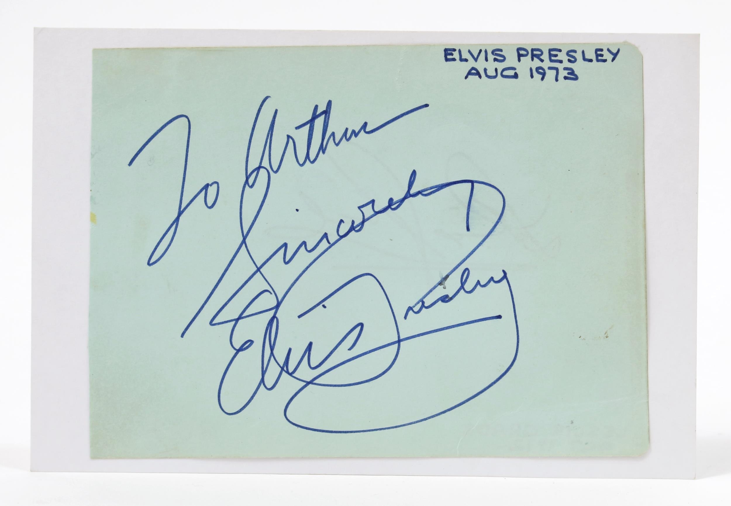 Autographs, Elvis Presley, The King - a signed page from an autograph album, pasted on rectangular shaped white card, 'TO ARTHUR, SINCERELY ELVIS PRESLEY' in blue ink, reputedly obtained by the original owner in August 1973 in the Hilton Hotel, Las Vegas  Provenance - the autograph was passed down to a family member and is accompanied with a copy of an extract taken from the Lancashire Telegraph on 21st August 2003. This lot is accompanied with a letter of authority and a personal note written by the previous owner.