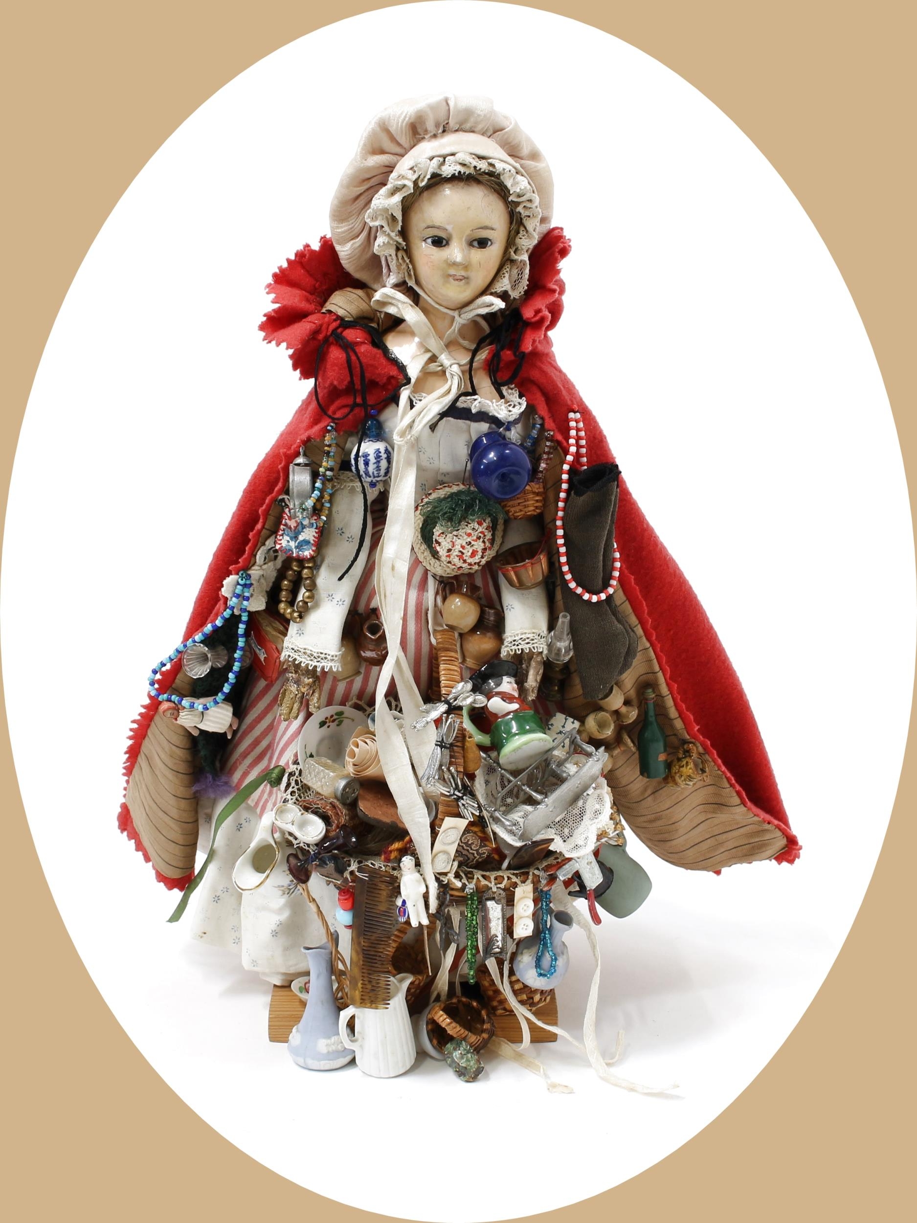 Toys From The Attic Part II - a 19th century painted papier-mâché shoulder head 'Pedlar' doll, the painted papier-mâché shoulder head with inset fixed brown glass eyes, painted features, blonde wig, kid leather body, she stands with a basket of wares and various items attached, 35cm high, displayed on a later associated wooden stand and later stand with glass dome