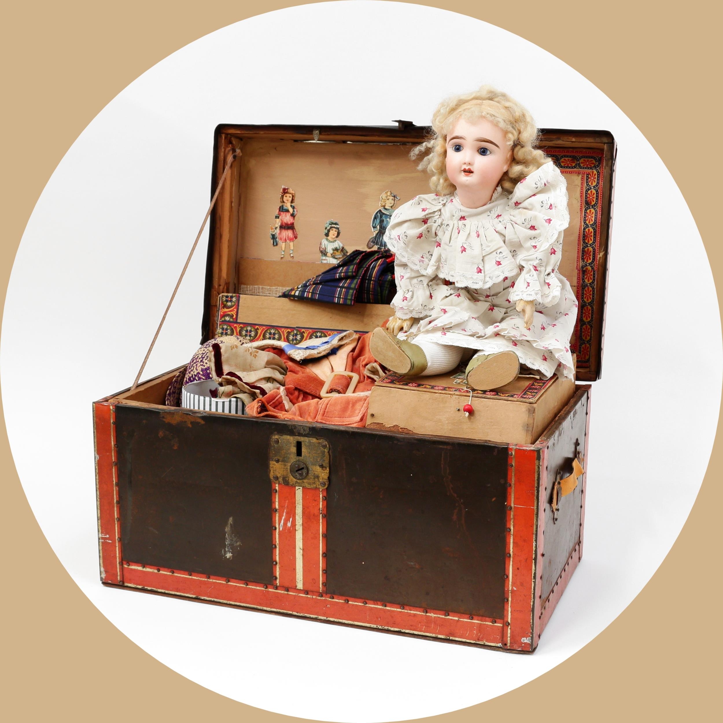 Toys From The Attic Part II - a Pintel & Godchaux (France) bisque head and painted and composition bodied Bèbè doll, the bisque head inset with fixed blue glass eyes, painted features including thick feathered brown eyebrows and fine eyelashes, open mouth revealing upper teeth, blonde wig on cardboard pate, impressed marks 'A, P.7.G.', 38cm high; together with a rectangular shaped miniature travel trunk, the interior fitted with a single lift out tray with various doll clothing and accessories (quantity)