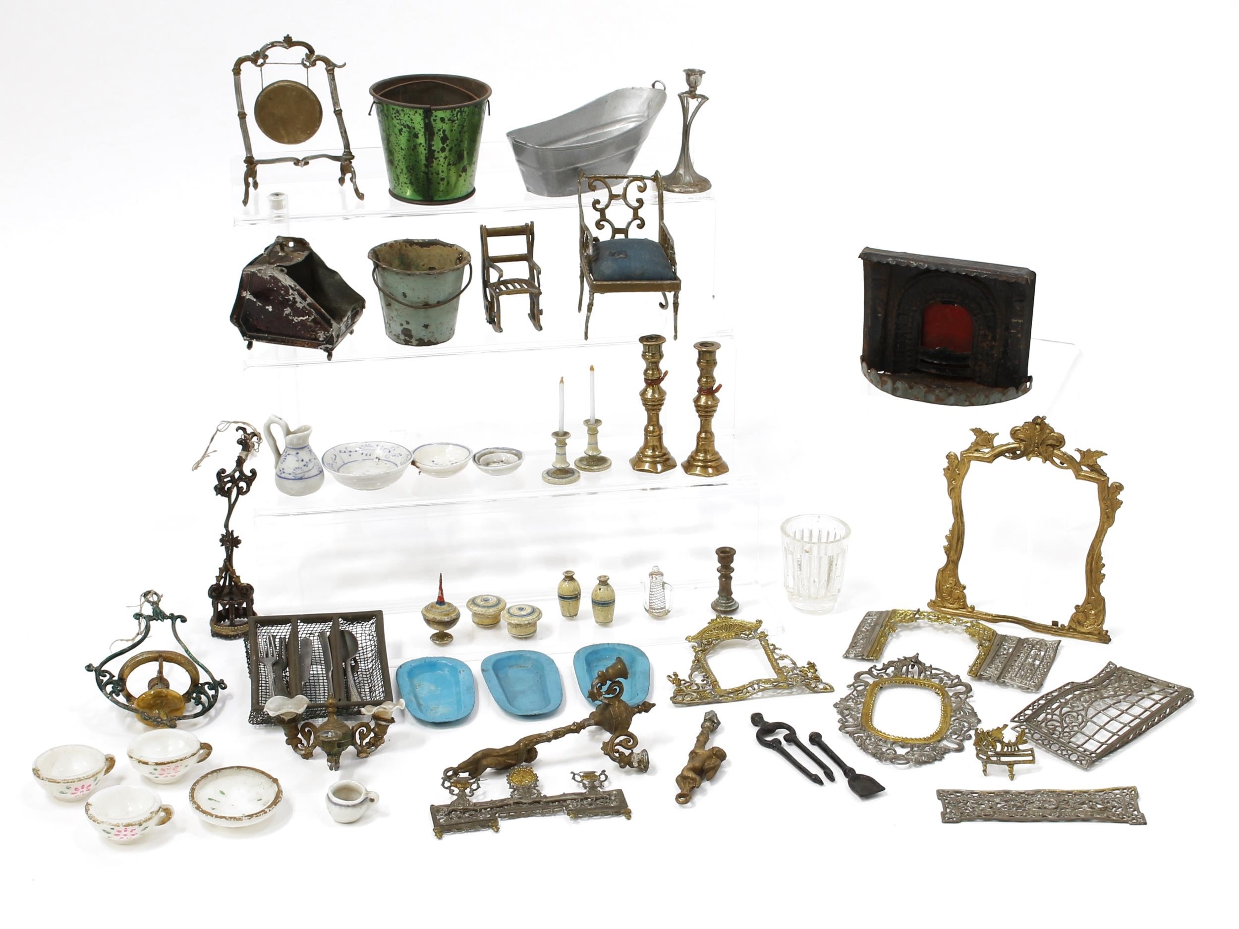 Dolls House Furnishings - a collection of late 19th century/early 20th century dolls house furniture, furnishings and accessories, comprising a pair of turned wooden and painted candlesticks, each inset with a faux candle finished in glass, each 5cm high; a pair of brass candlesticks, hexagonal bases, each 6cm high; a Victorian style tinplate fireplace and surround etc (quantity)