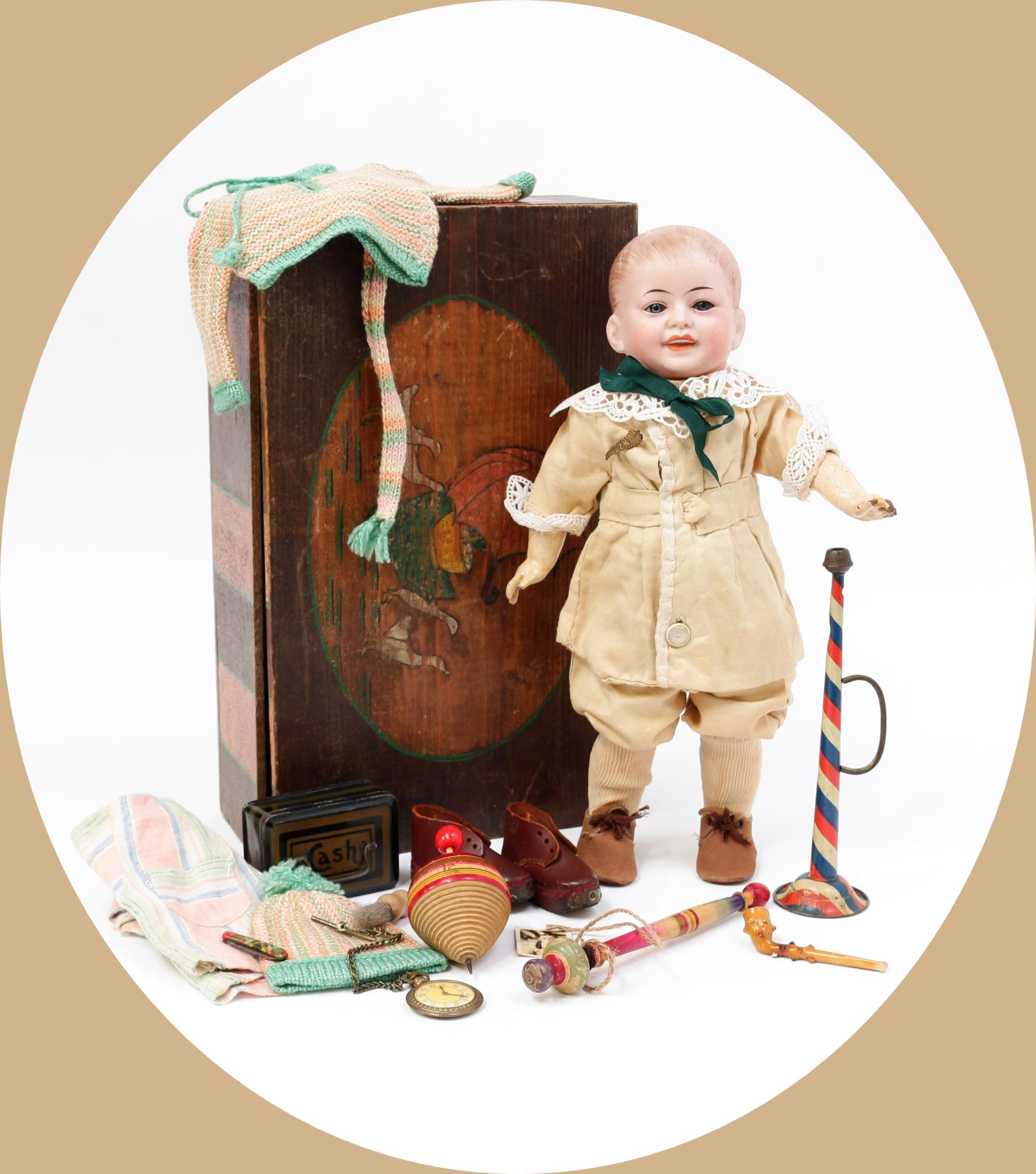 Toys From The Attic Part II - an S.F.B.J. (Société Francaise de Fabrication de Bébé & Jouets, France) bisque head and painted composition bodied character doll, the bisque head inset with fixed blue glass eyes, painted features including thick brown eyebrows and fine eyelashes, moulded and painted mouth revealing upper teeth, brown painted hair, impressed marks '227-0', 33cm high; together with a rectangular shaped painted pine box and cover with various doll clothing, accessories and novelties (quantity)