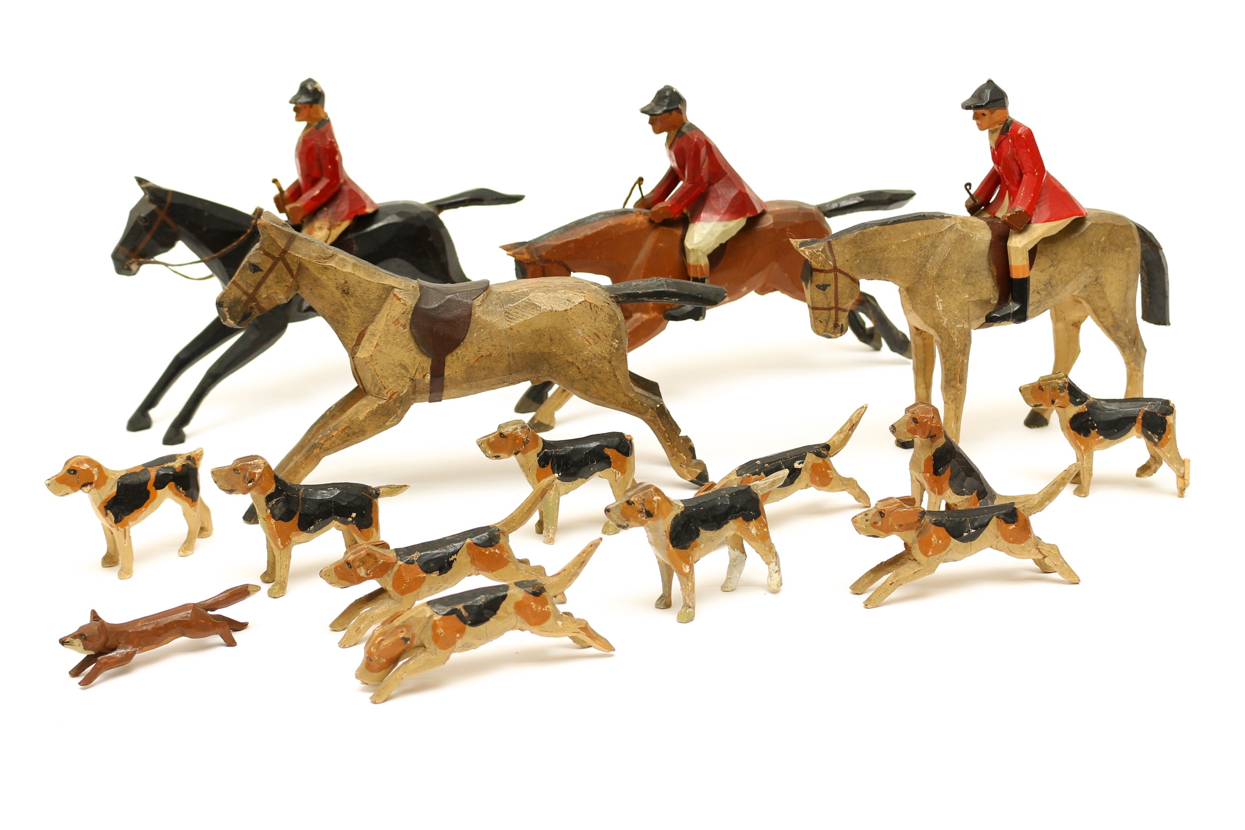 English Folk Art, Frank Whittington's Forest Toys of Brockenhurst - a collection of hand carved and painted wooden figures from The Hunting set, comprising three Huntsmen on Horses with riding crops, a single unmounted Horse, ten Hounds in various poses and a Fox (15)