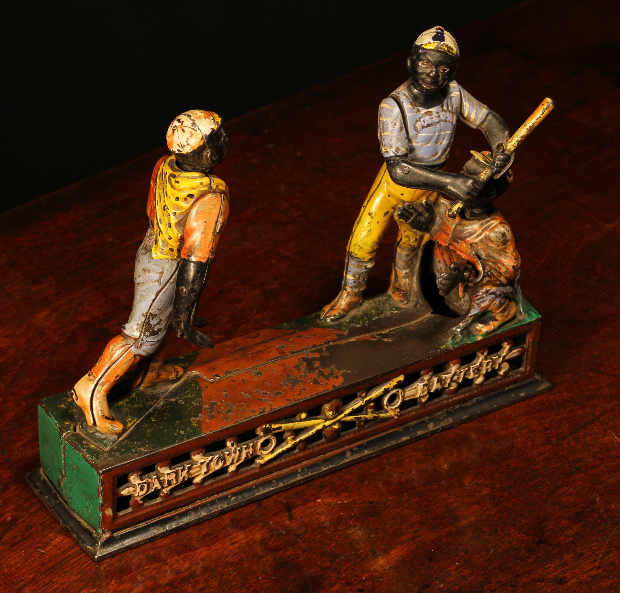 Americana, Sporting Interest - a late 19th century painted cast iron novelty mechanical money box or bank, Dark Town Battery, modelled as a group of figures playing Baseball, mounted upon a shaped rectangular base, manufactured by manufactured by J. & E. Stevens Co., pierced base plate, 19.5cm high