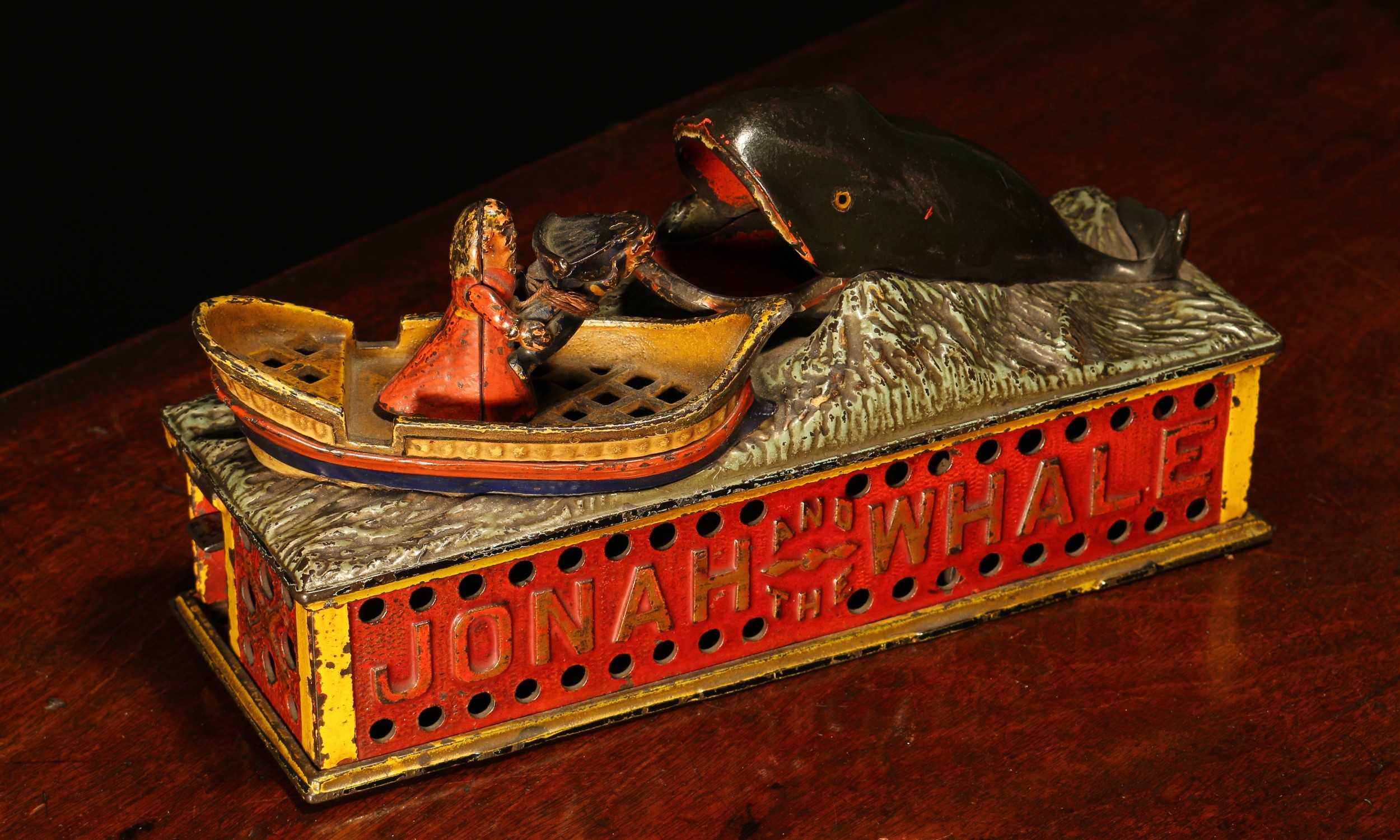 Americana - a late 19th century painted cast iron mechanical money box or bank, Jonah and the Whale, manufactured by the Shepard Hardware Co., the pierced base plate inscribed 'PAT JULY 15 1890', 14cm high, with key