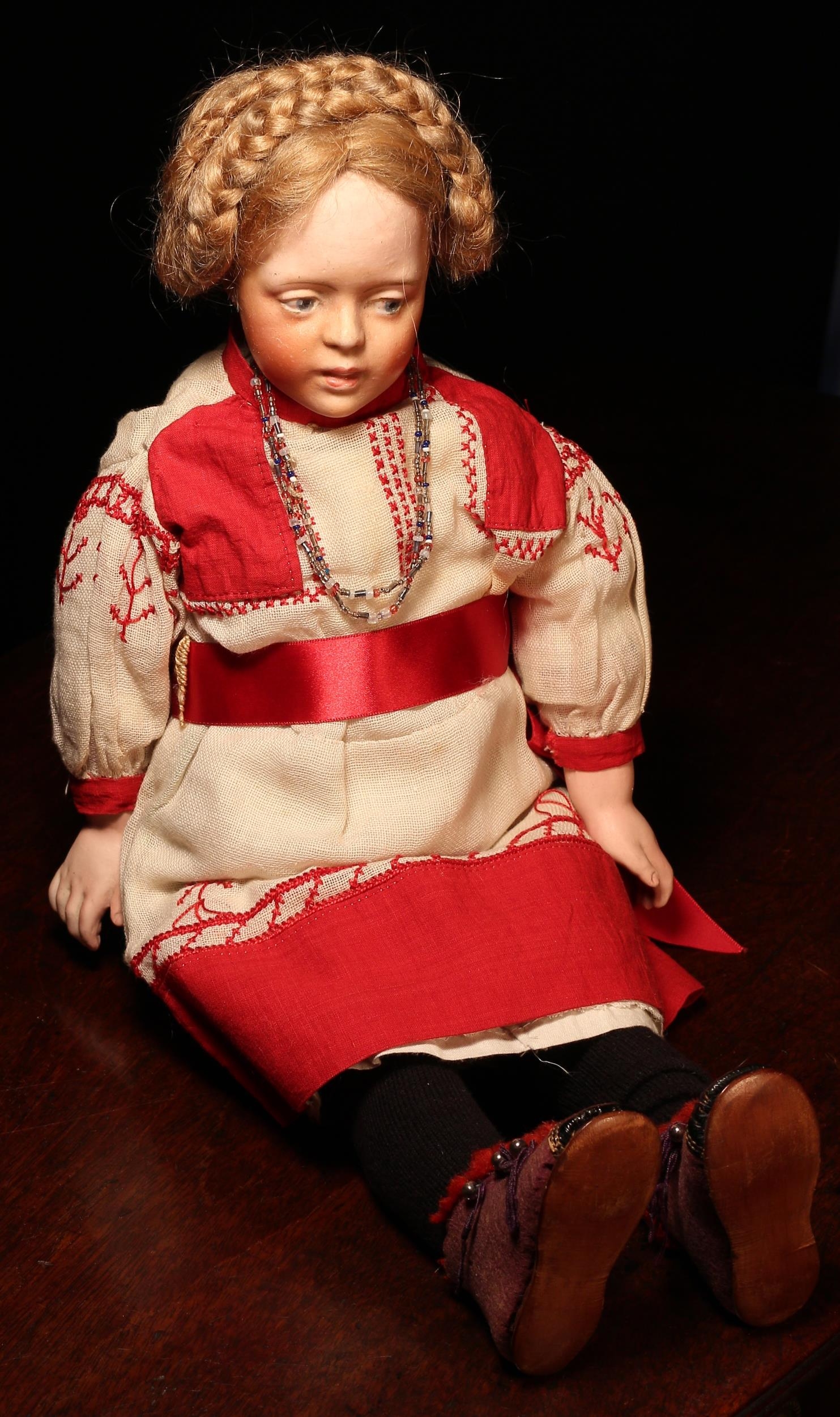 A bisque shoulder head character doll, the bisque shoulder head with blue side glancing intaglio eyes, painted features including brown feathered eyebrows and red lips, blonde wig, partially stuffed cloth body with oversized bisque lower arms and lower legs, impressed and painted marks '163', 44cm high