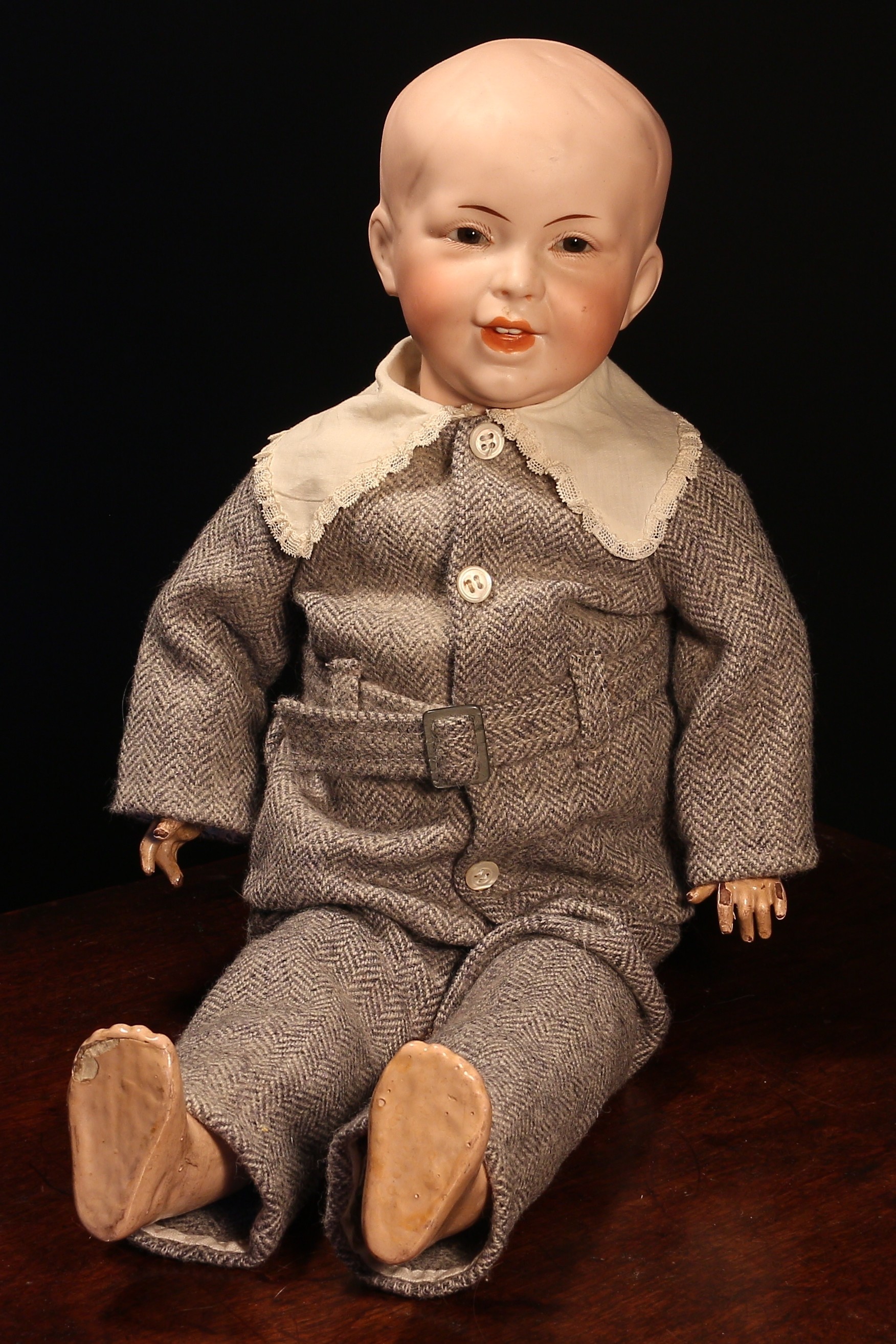 An SFBJ (France) bisque head and painted composition bodied character doll, the bisque head with fixed inset brown glass eyes, painted features including brown eyebrows and fine eyelashes, moulded open mouth revealing upper teeth, impressed marks 'S.F.B.J. 235 PARIS, 8', 51cm high