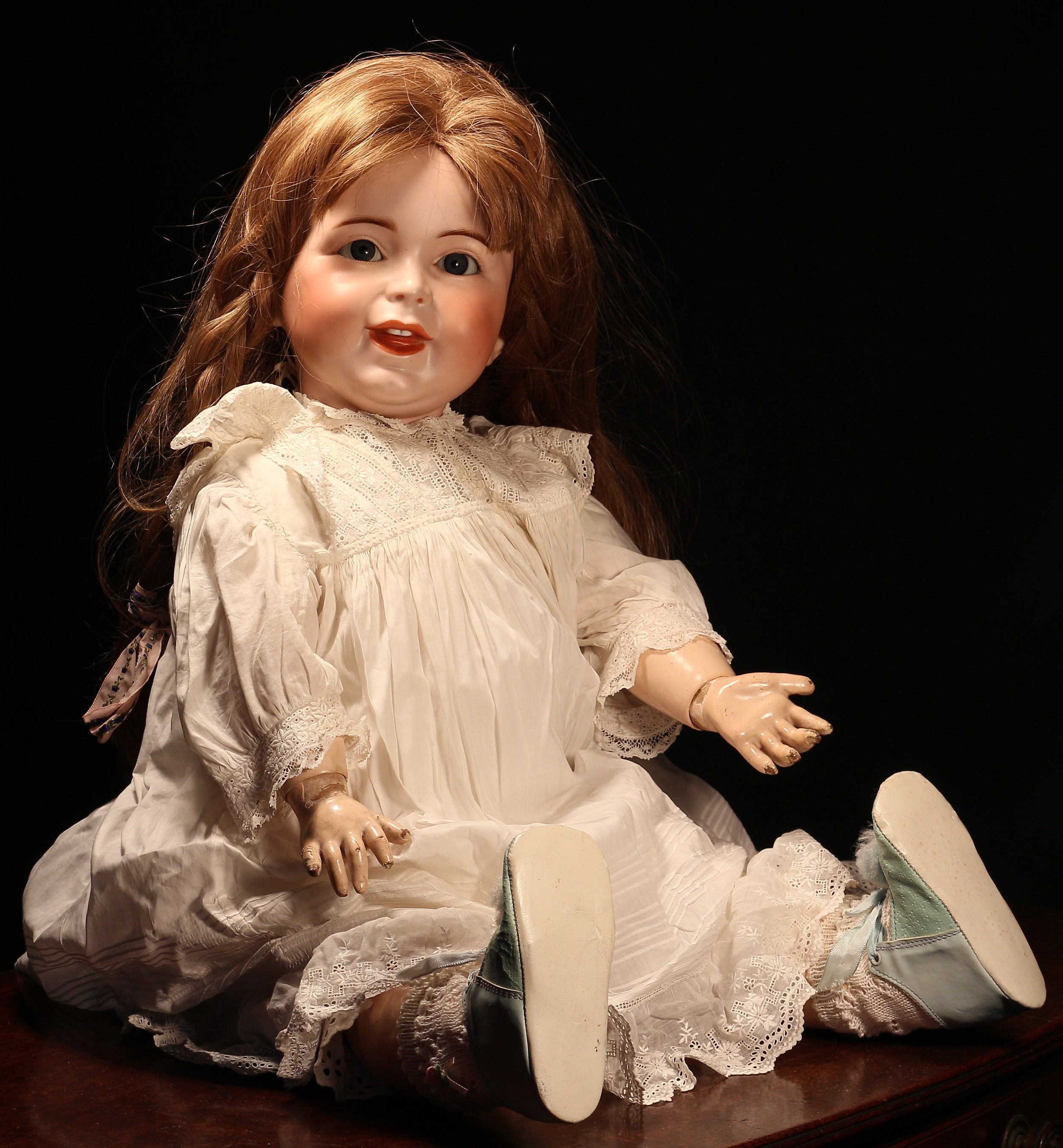 An SFBJ (France) bisque head and painted composition bodied character doll, the bisque head with weighted sleeping blue glass eyes, painted features including feathered brown eyebrows and fine eyelashes, moulded mouth with teeth, brown wig, impressed marks 'S.F.B.J. 236 PARIS 12', 67cm high