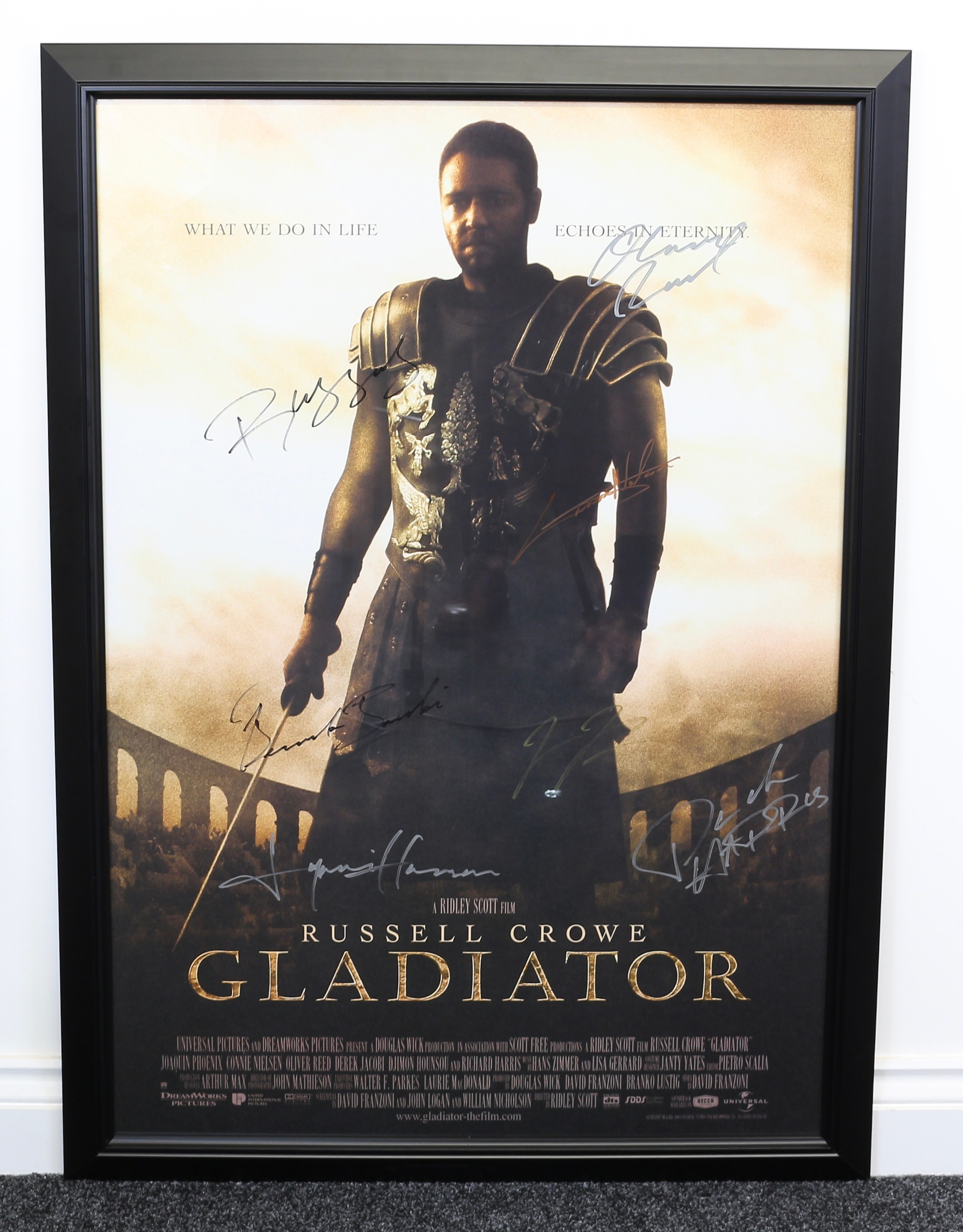 Poster, Film, Cinema & Movie Interest, Autographs - a rectangular shaped poster for the Ridley Scott film Gladiator, signed in pen, various signatures including Oliver REED, Russell CROWE, Connie NIELSEN, Joaquin PHOENIX, Richard HARRIS, others, framed, 96cm high, 66cm wide (measurements excluding frame)