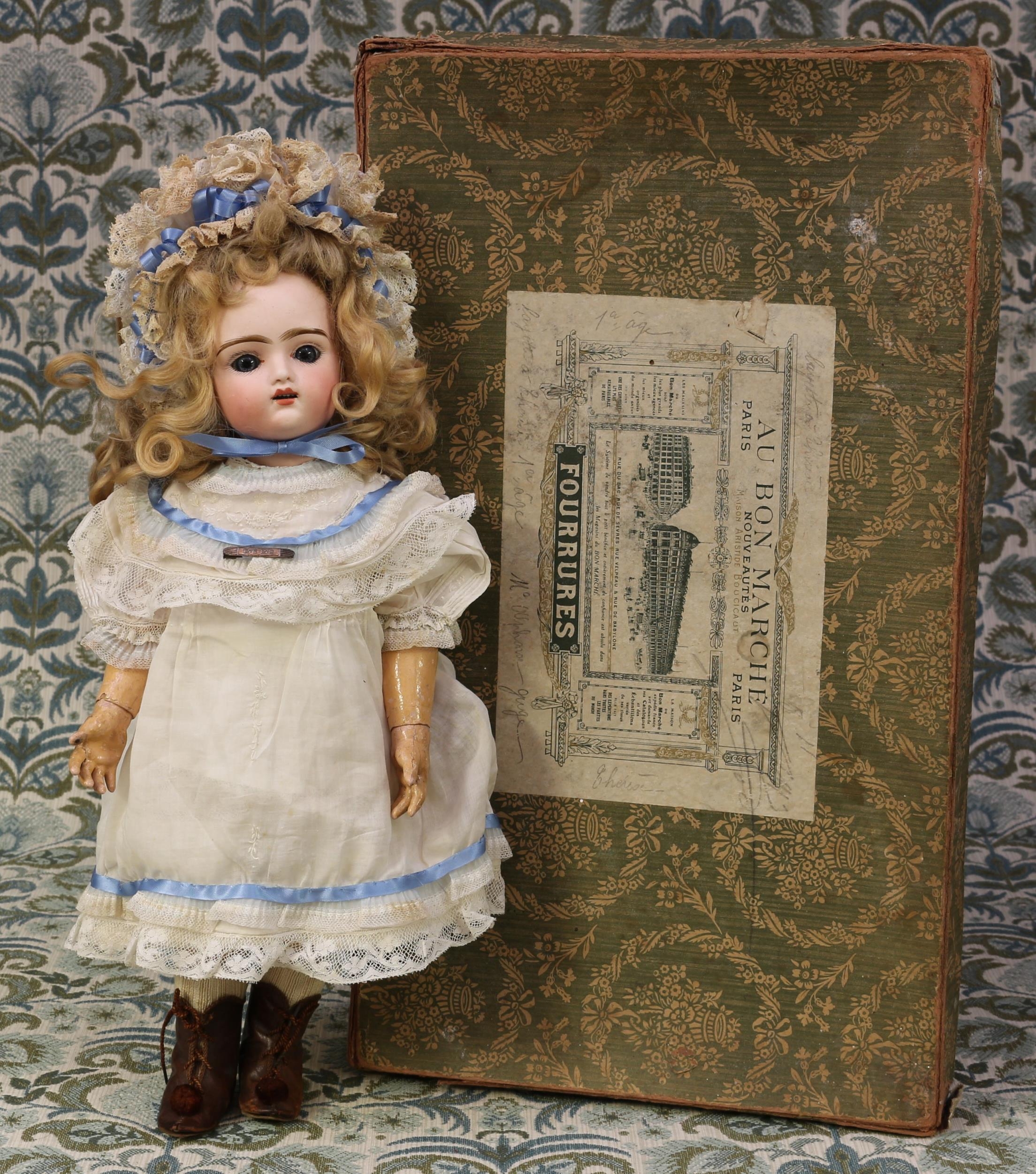 A late 19th century/early 20th century French bisque head and painted composition bodied automaton walking doll, the bisque head with fixed inset blue glass eyes, painted features including brown feathered eyebrows and fine eyelashes, open mouth revealing teeth, blonde wig on cork pate, impressed marks 'C. DEPOSE *8, 6', fixed key wind mechanism and lever with key initialled 'RD' for Roullet & Decamps (France), boxed - rectangular shaped cardboard box with lid, the lid with a rectangular shaped label for Au Bon Marché, Paris