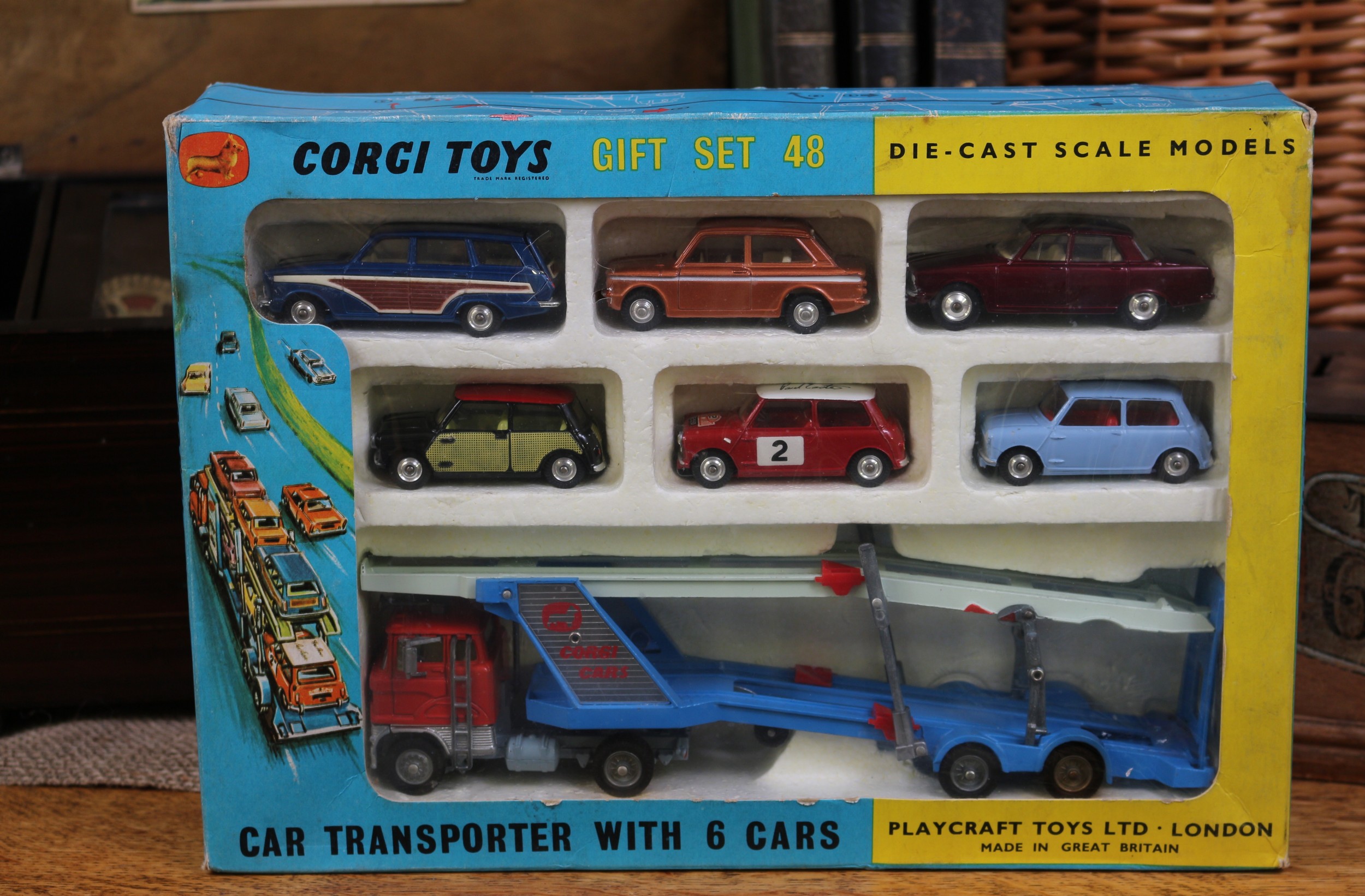 Corgi Toys Gift set 48, comprising 1138 Carrimore car transporter with Ford tilt cab, orange cab with two tone blue transporter; 252 Rover 2000, metallic maroon body with cream interior, spun hubs; 251 Hillman Imp, metallic bronze body with white flashes, cream interior, spun hubs; 440 Ford Consul Cortina super estate car, metallic blue body with faux side panels, cream interior, spun hubs; 249 Morris Mini Cooper DeLuxe, black body with faux 'wickerwork' side panels and red roof, lemon yellow interior, spun hubs; 321 Mini Cooper 'S', red body with white roof, Monte Carlo decals and racing number '2' to side doors, red interior, spun hubs; 226 Morris Mini-Minor, pale blue body, red interior, spun hubs, window boxed with polystyrene display piece, original instructions sheet and eighteen plastic traffic cone accessories