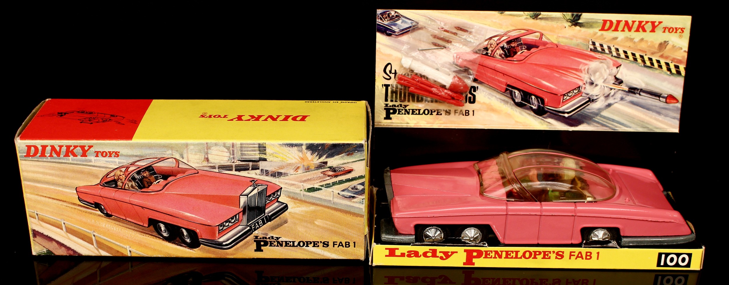 Dinky Toys 100 Lady Penelope's FAB 1 from the Gerry Anderson T.V. series Thunderbirds, pink body, gold interior, seated plastic figures of Parker and Lady Penelope to interior, clear plastic sliding roof, boxed with original inner pictorial display stand with plastic rocket and harpoons in stapled plastic packet