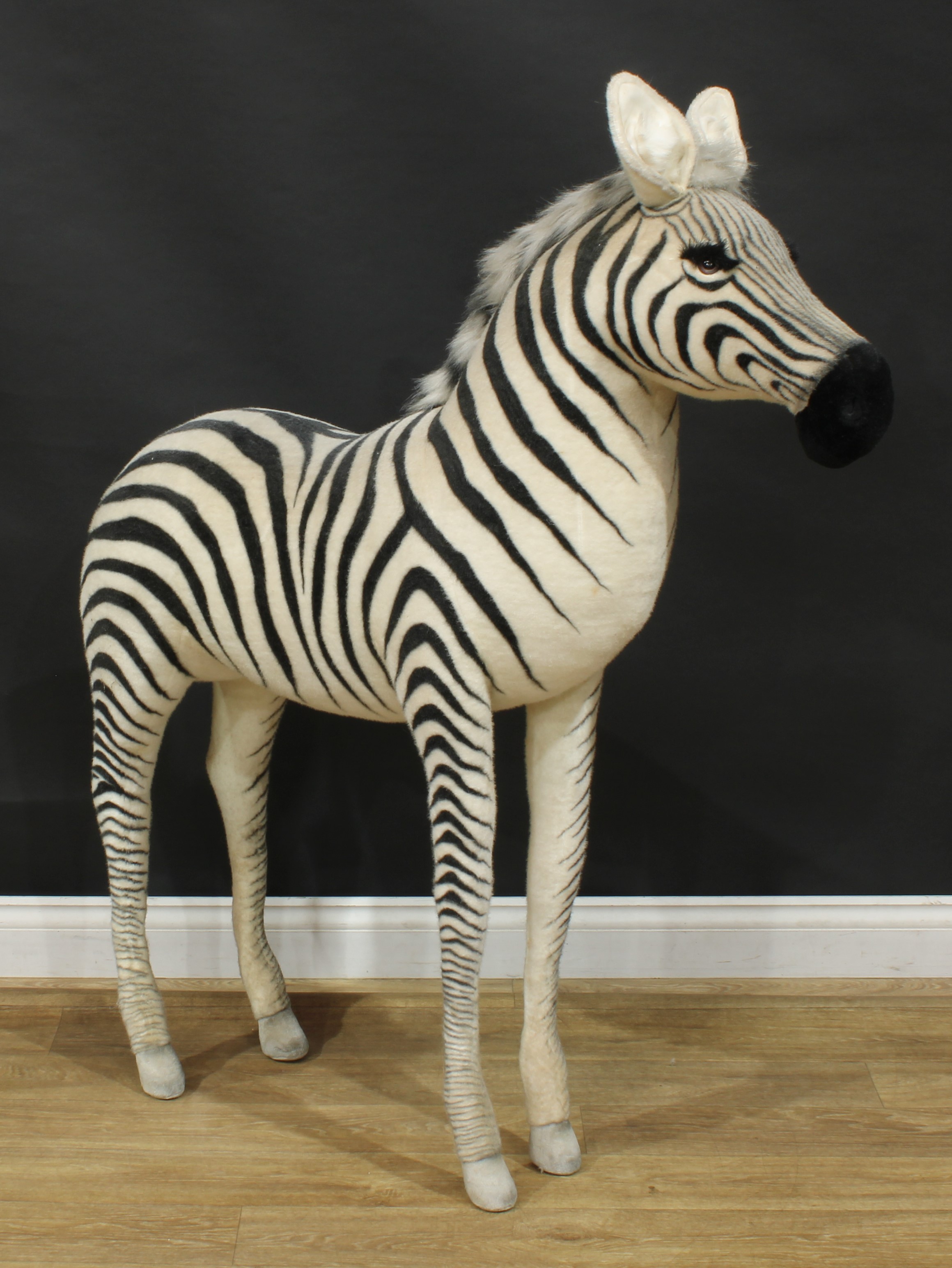 A large shop display/point of sale model of a Zebra, probably by Steiff (Germany) or similar, brown and black plastic eyes, white body with black stripes, 131.5cm high