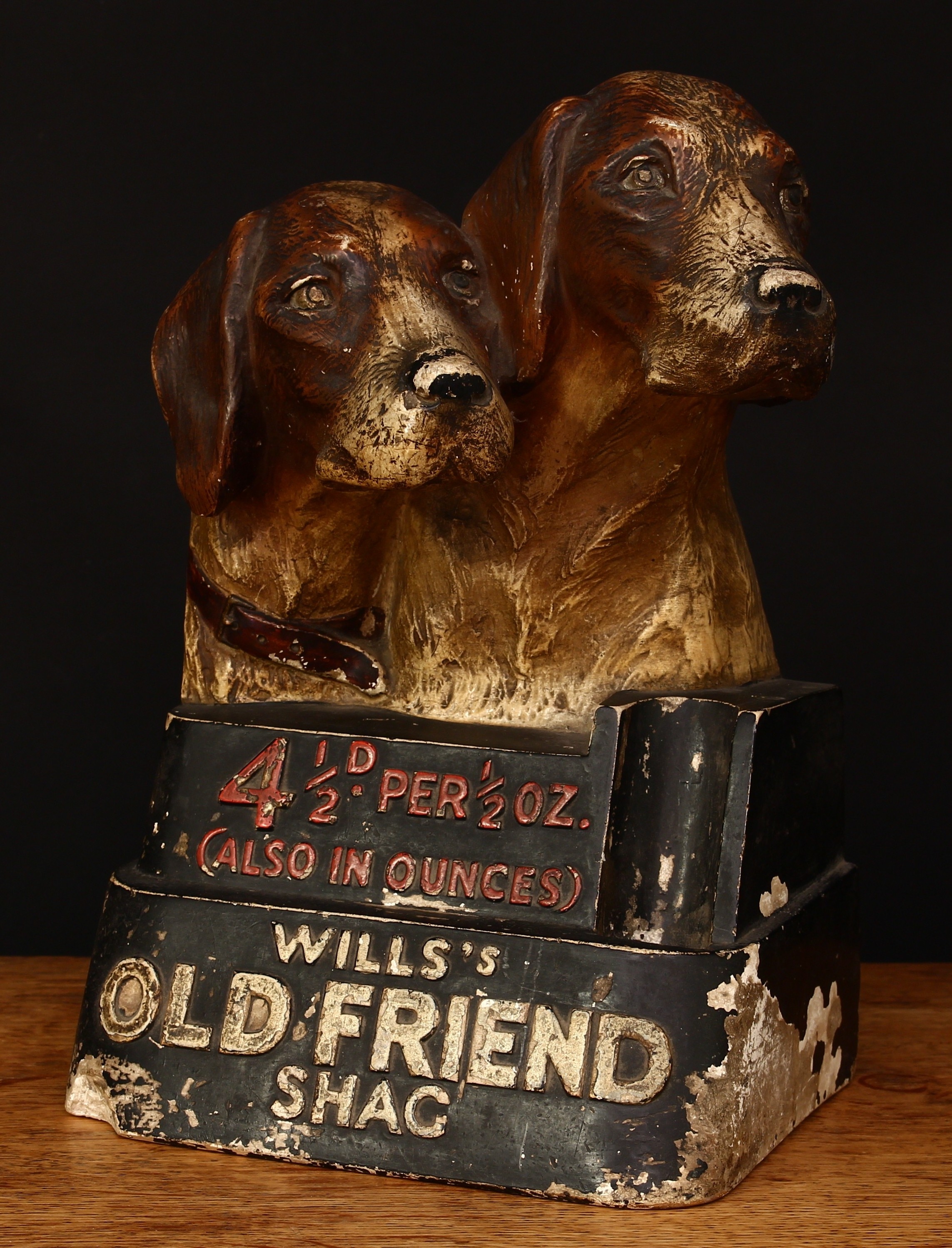Advertising, Tobacciana & Smoking Interest, W.D. & H.O. Wills - an early 20th century painted plaster or chalk ware point of sale advertising display piece, modelled with the heads of two Fox Hounds, '4½D. PER ½OZ. (ALSO IN OUNCES), WILLS'S OLD FRIEND SHAG', impressed mark to the reverse side 'I.T.C. 10310.', 30cm high