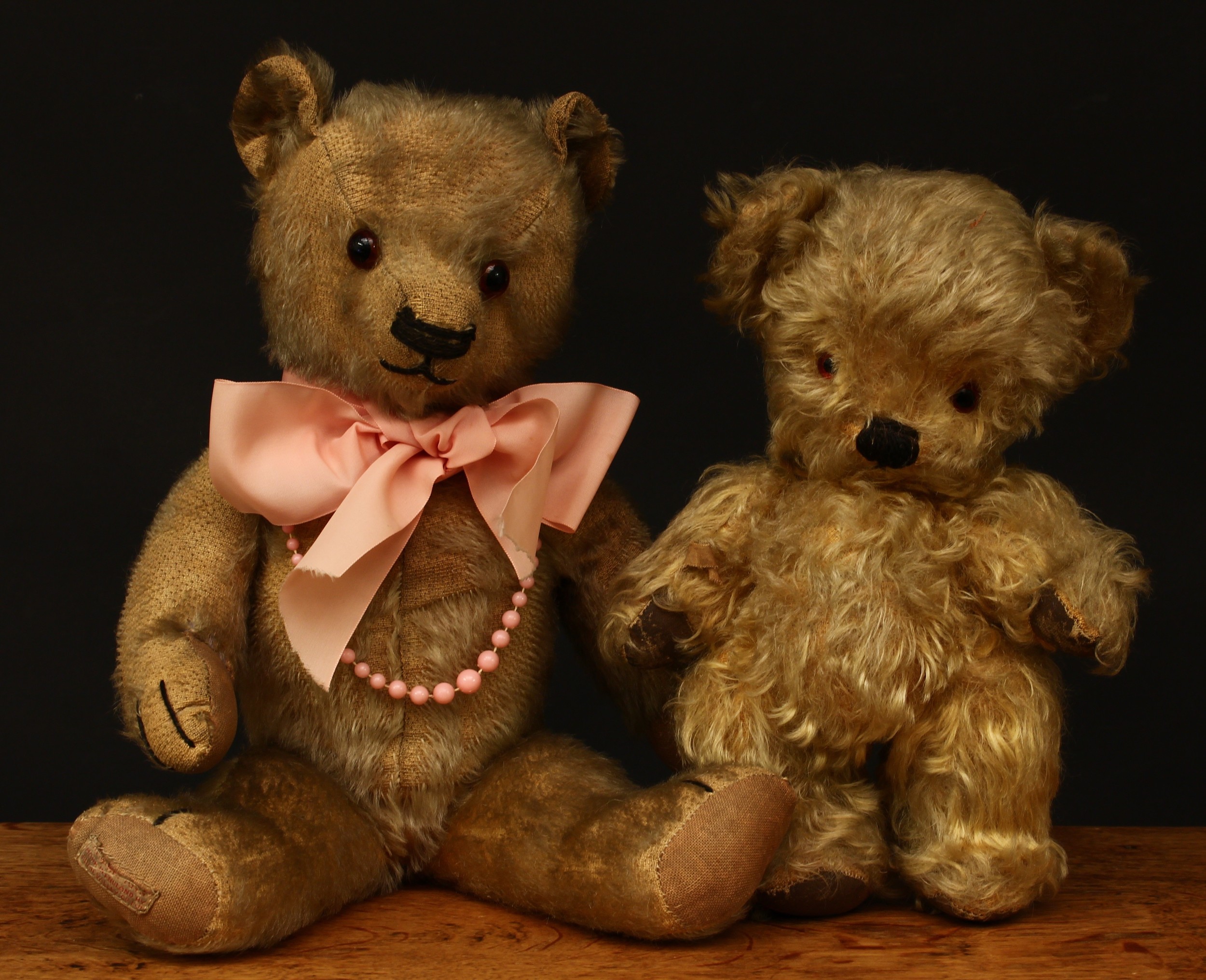 A 1930's Chad Valley novelty golden mohair jointed teddy bear, amber and black glass eyes, vertically and horizontally stitched nose and mouth, brown rexine pads to hands and feet, trademark blue and white rectangular shaped label to arm 'HYGIENIC TOYS, MADE IN ENGLAND BY CHAD VALLEY CO.LTD', 24cm high; another Chad Valley teddy bear, 38cm high (2)