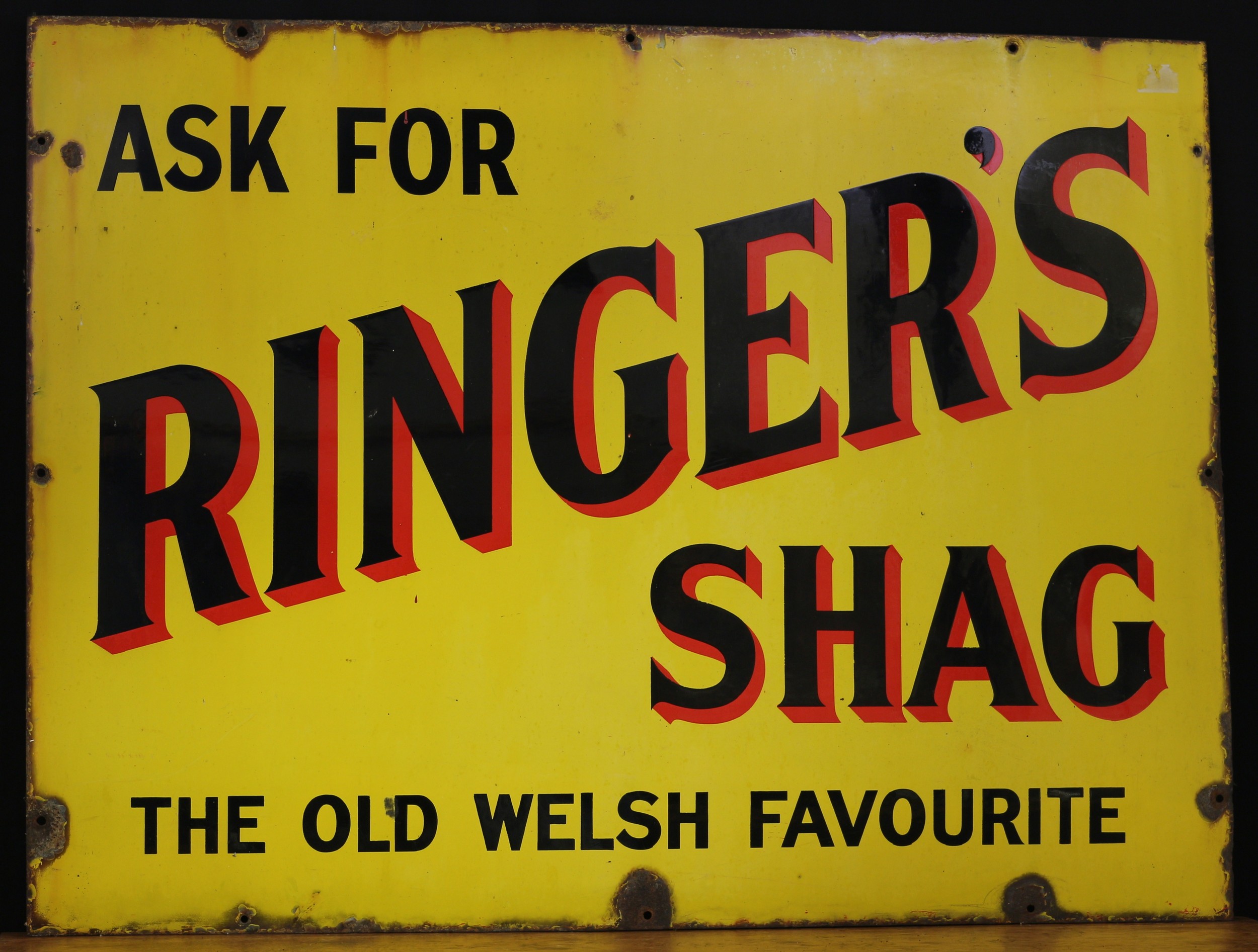 A rectangular enamel sign, 'ASK FOR RINGER'S SHAG, THE OLD WELSH FAVOURITE'