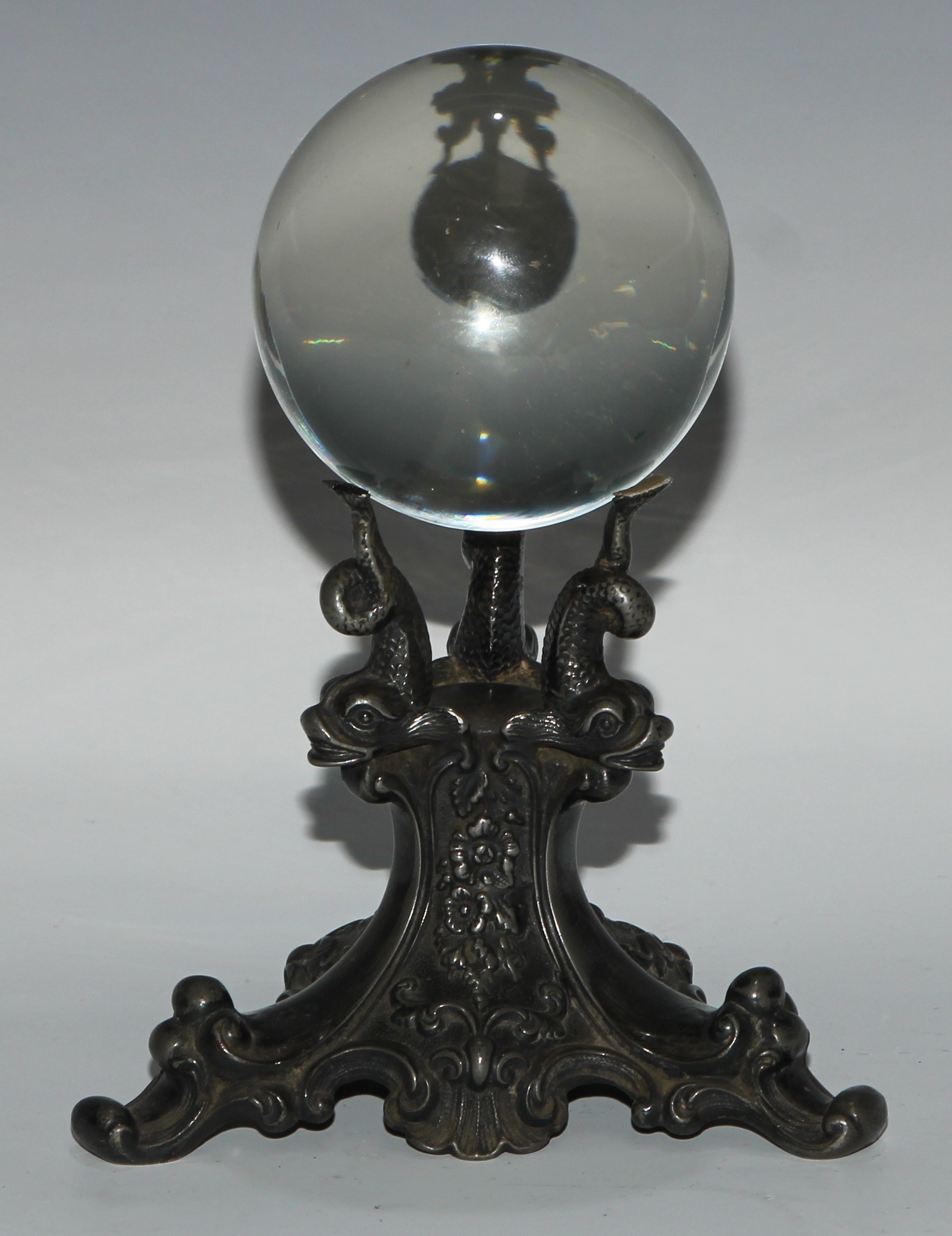Mysticism and the Occult - a crystal ball, the triform stand in relief with dolphins, flowers and scrolls, 20cm high